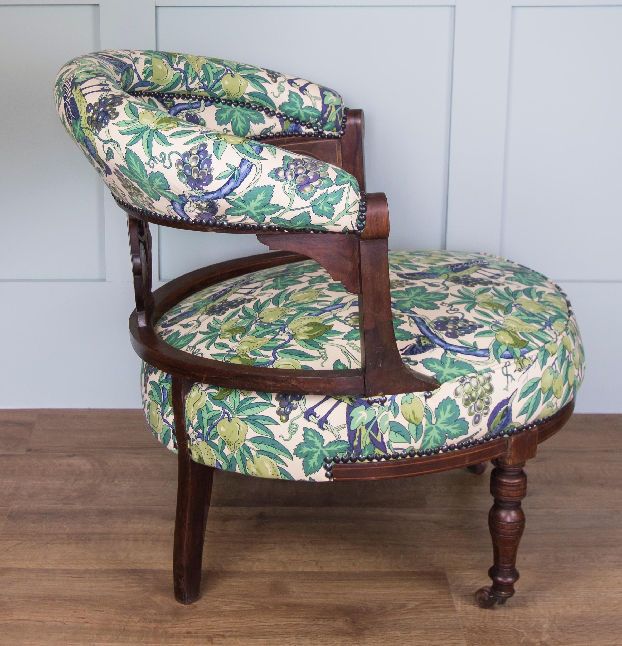 This beautiful little chair has been fully reupholstered using a vintage 1970s cotton furnishing fabric by the famous Liberty of London. Metal, antique black studwork secures the fabric. Greens, blues and purples come through in this delightful bird