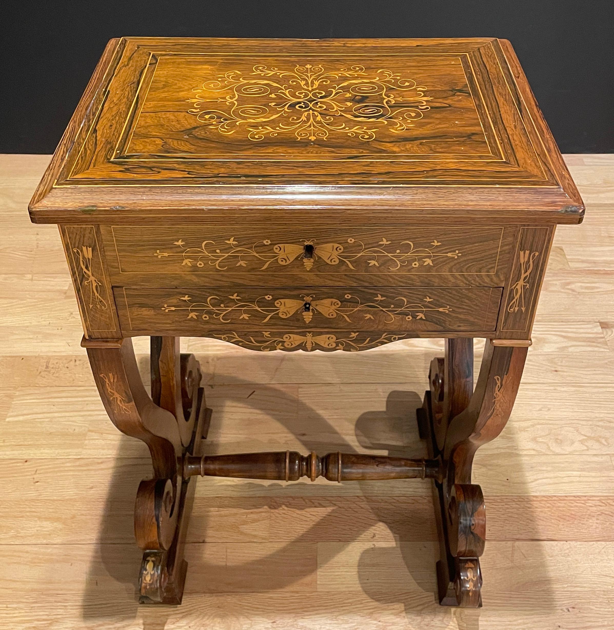 Fine quality Regency style 19th century rosewood and marquetry work table. Interior with individual compartments and mirror inside back of top. Inlay with butterflies and vines and leaves along with bow and arrows.