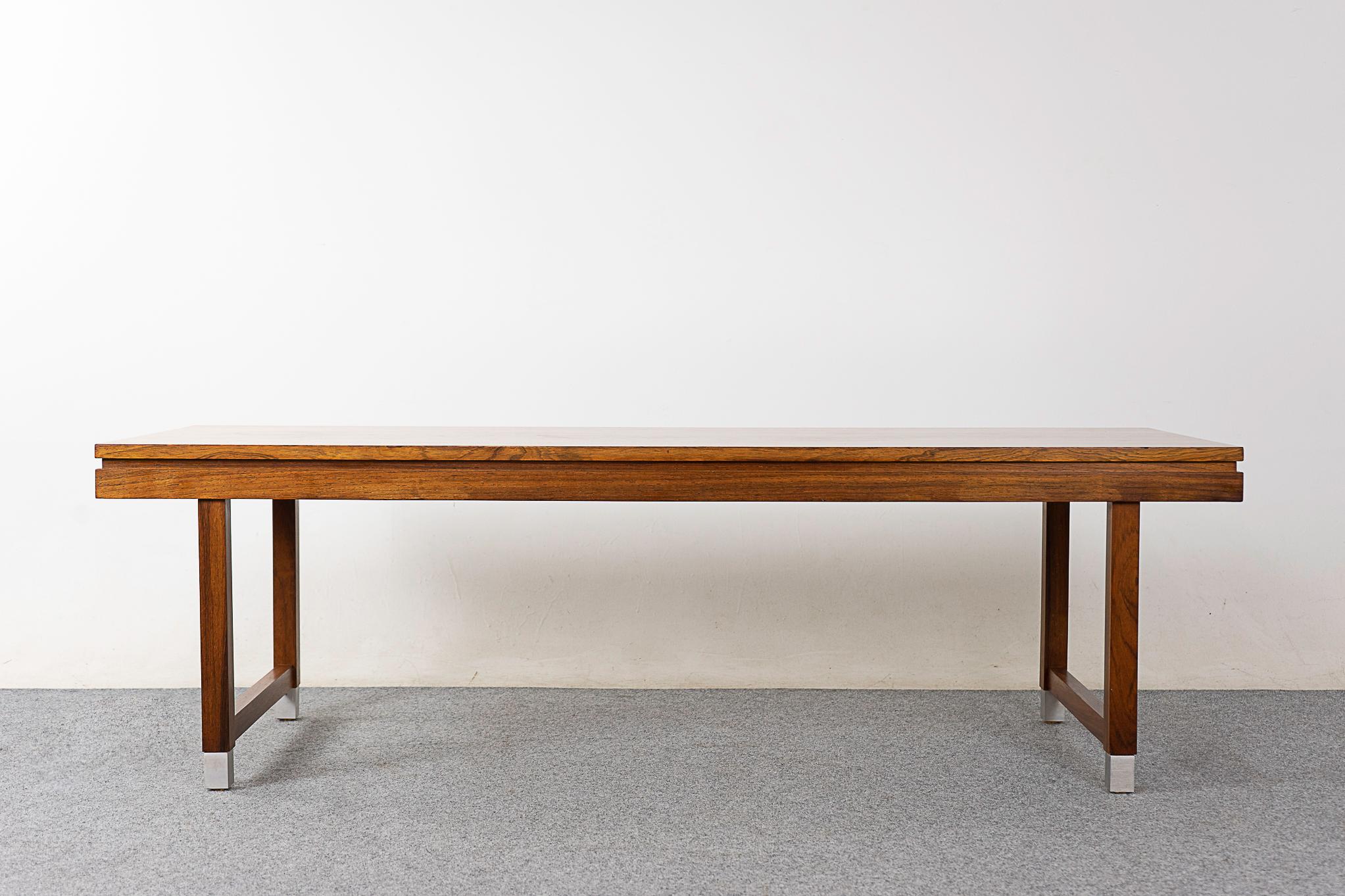 Rosewood and metal mid-century coffee table, circa 1960's. Book matched veneer and solid wood trim. Sleek edges with recessed detail and metal feet.

Unrestored item with option to purchase in restored condition for an additional $200 USD.