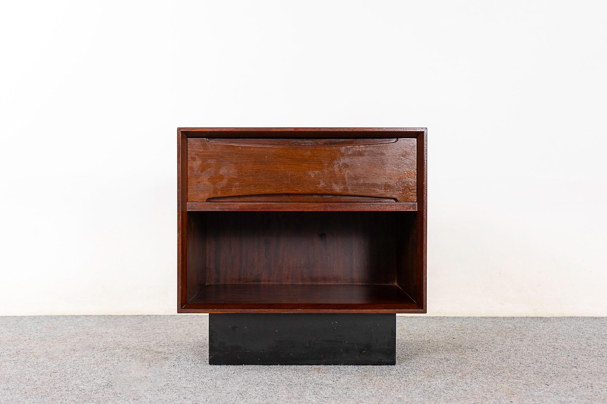 Rosewood bedside table by Drylund, circa 1960's. Compact size with dovetailed drawer and open stoarge cubby.

Unrestored item with option to purchase in restored condition for an additional $100 USD. Restoration includes: repairs, sanding, staining