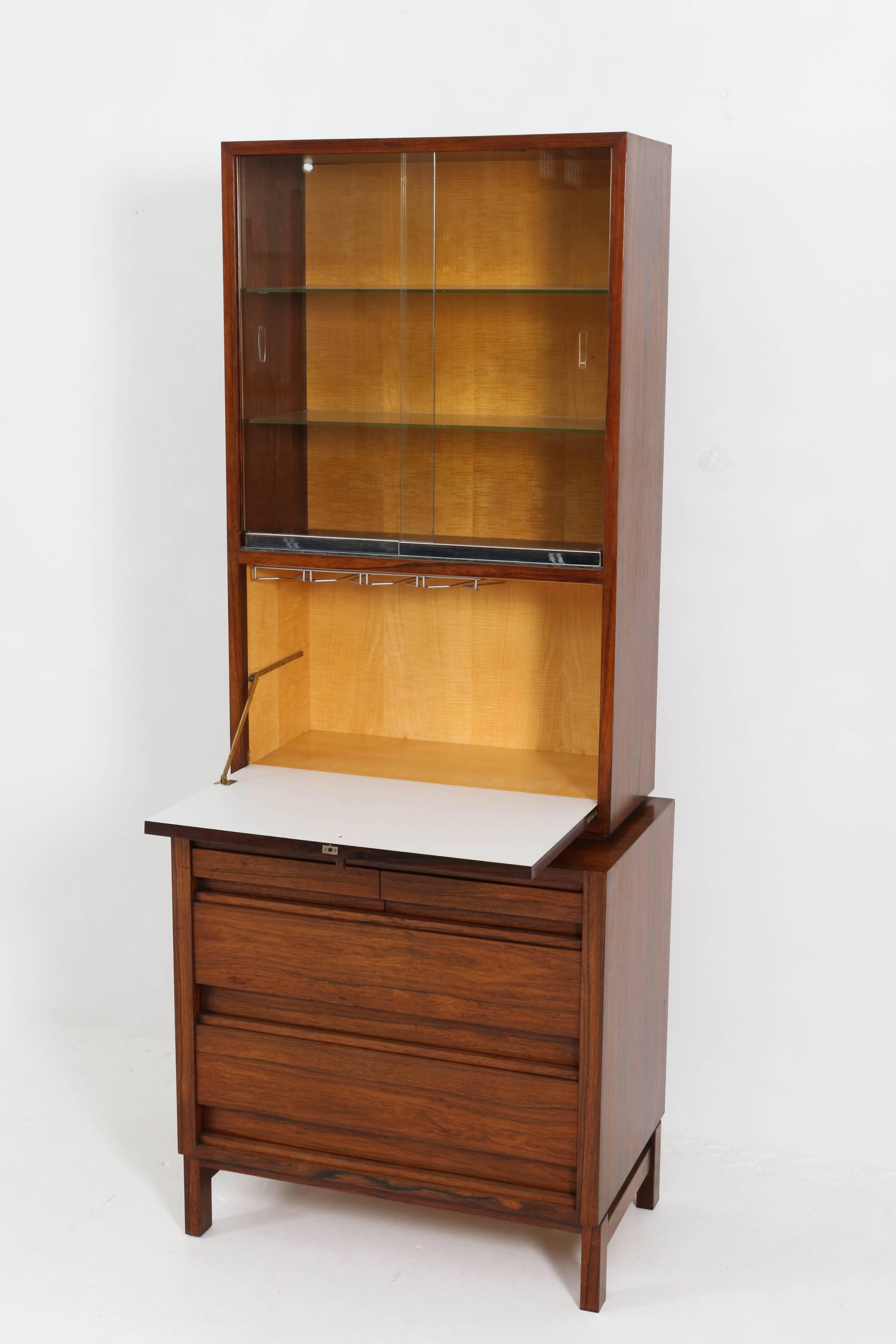 Rare Mid-Century Modern bar cabinet, 1960s.
Rosewood and rosewood veneer.
Original glass sliding doors.
In the two big drawers, you can store 10 bottles of wine etc.
In good original condition with minor wear consistent with age and
