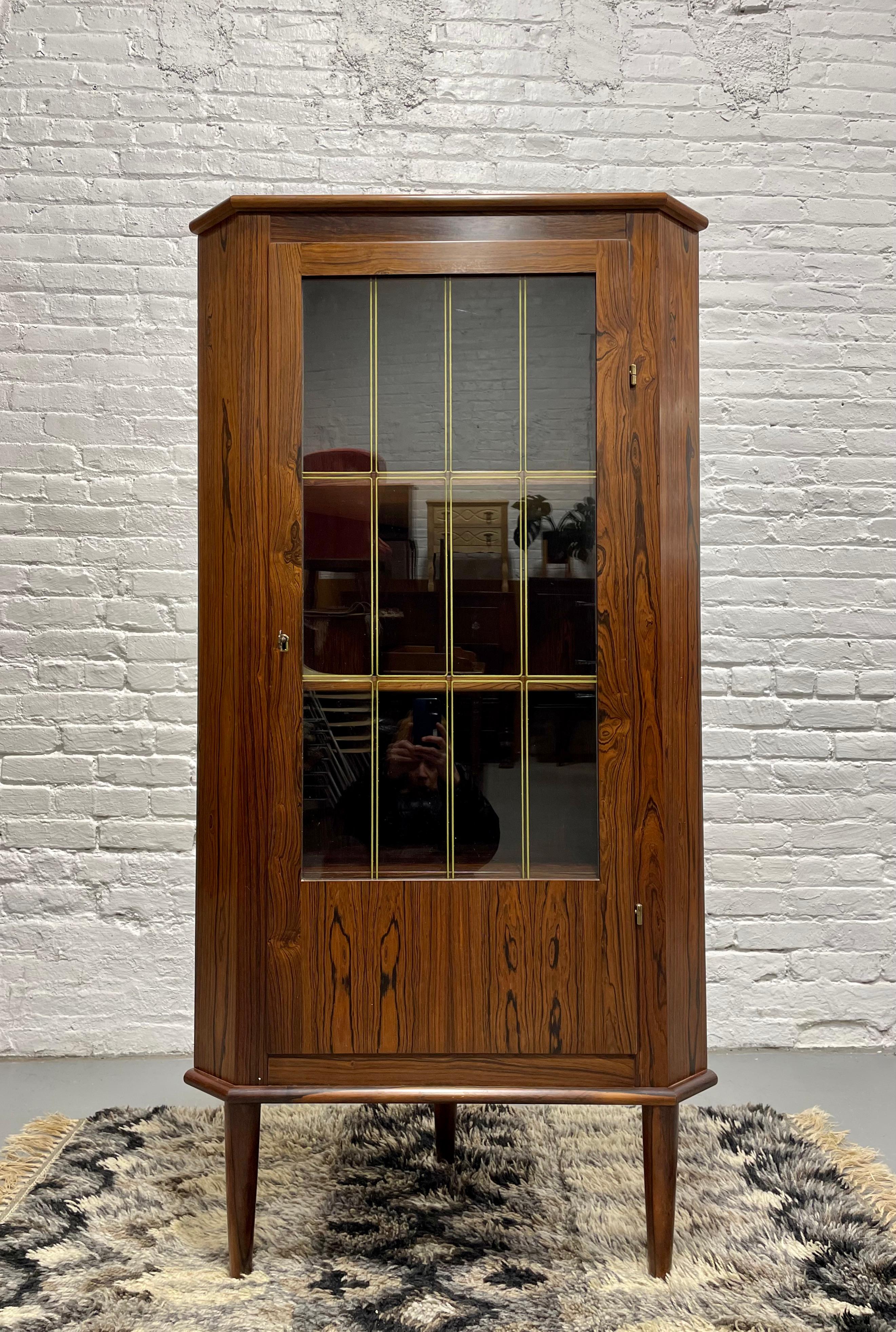 Mid Century Modern Rosewood corner bookcase / china or liquor cabinet, Made in Denmark, c. 1960's. This piece boasts stunning wood grains, both inside and outside the cabinet and is perfect where space is an issue as it offers plenty of storage