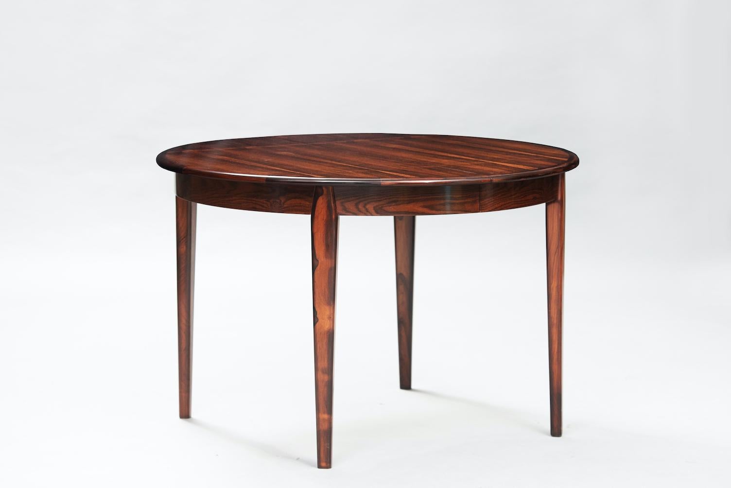 Rosewood Mid-Century Modern Danish extendable round dining table.