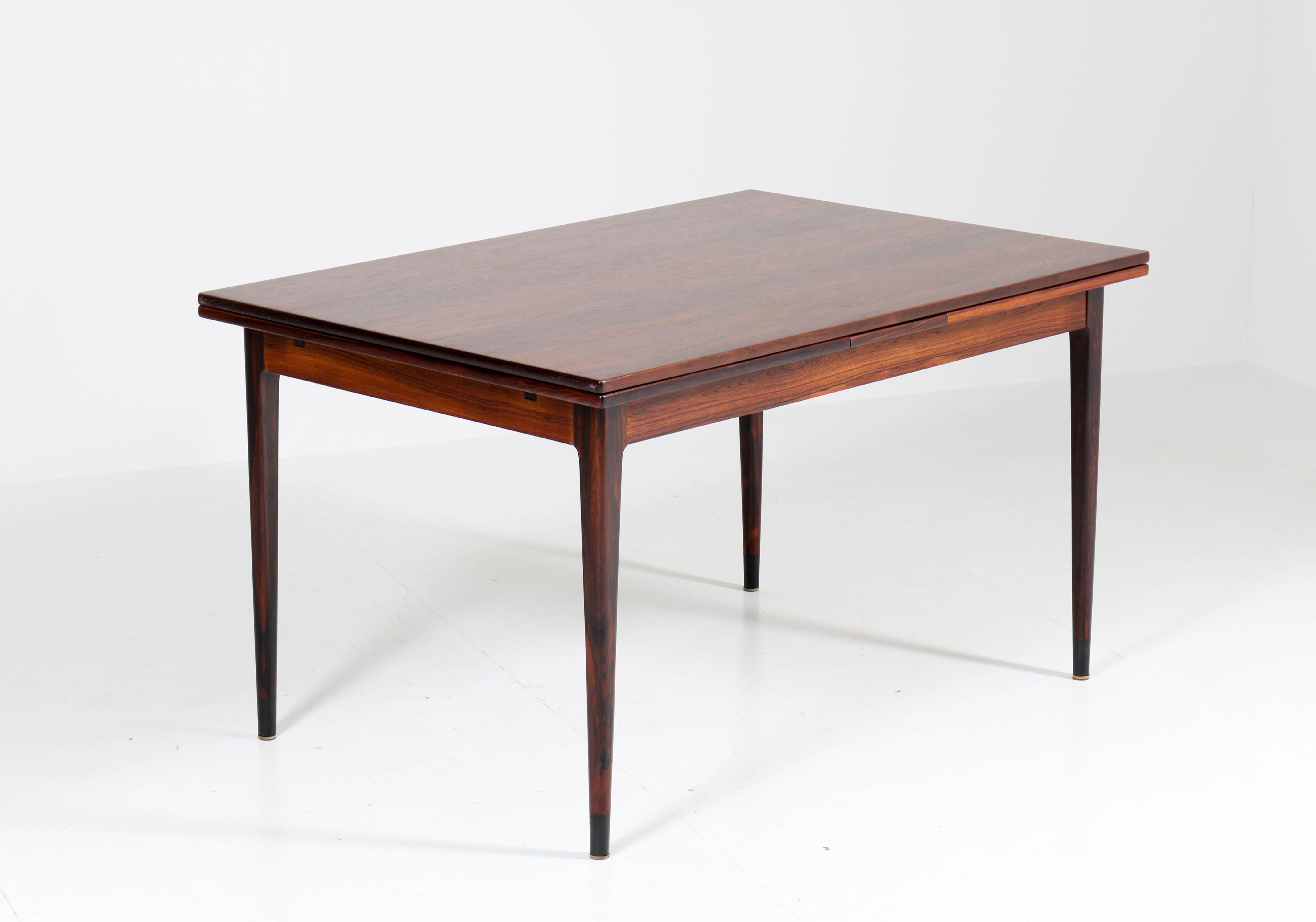 Wonderful and rare Mid-Century Modern extending table.
Design by Niels O. Møller for J.L. Møllers Møbelfabrik.
Iconic Danish design from the 1960s.
Solid rosewood with rosewood veneered top.
Marked with manufacturers mark.
Measurements not