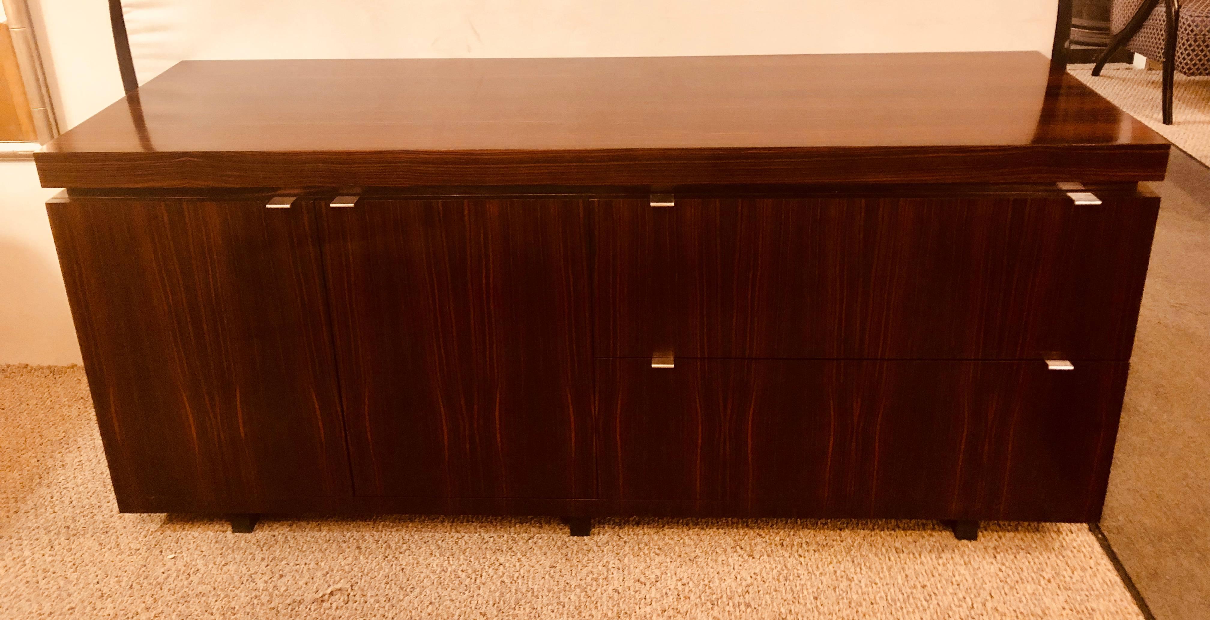 A rosewood Mid-Century Modern floating office sideboard with filing cabinets. This recently fully polished custom quality credenza cabinet appears to be floating on air. Having two doors leading to a shelved interior and two side sliding file