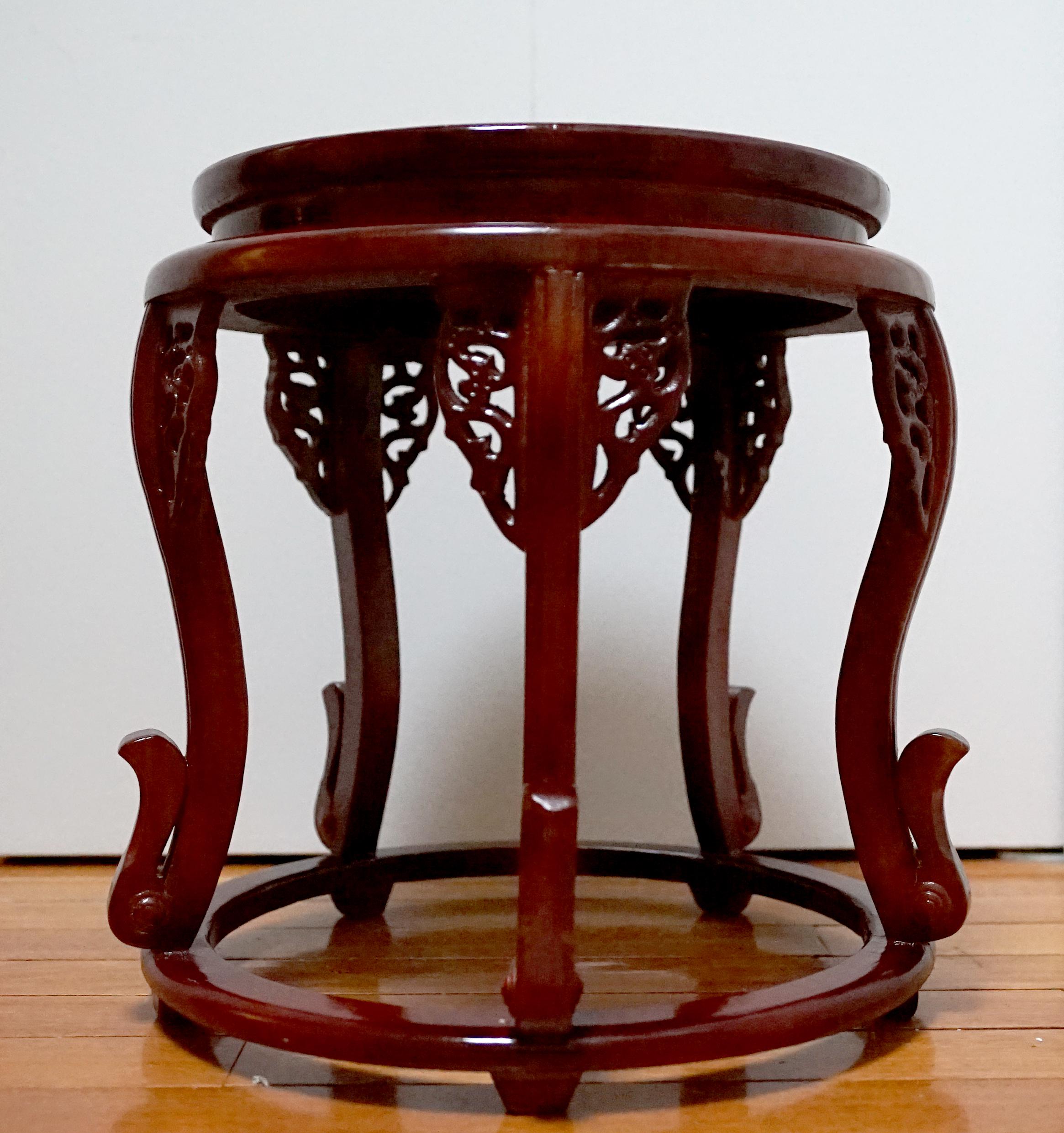 The form of this rosewood circular table with delicate fretwork and graceful legs is rare and worth a second look. The outstanding feature aside from the design details is the dark cherry-colored patina that can only come with age. The wood tone is