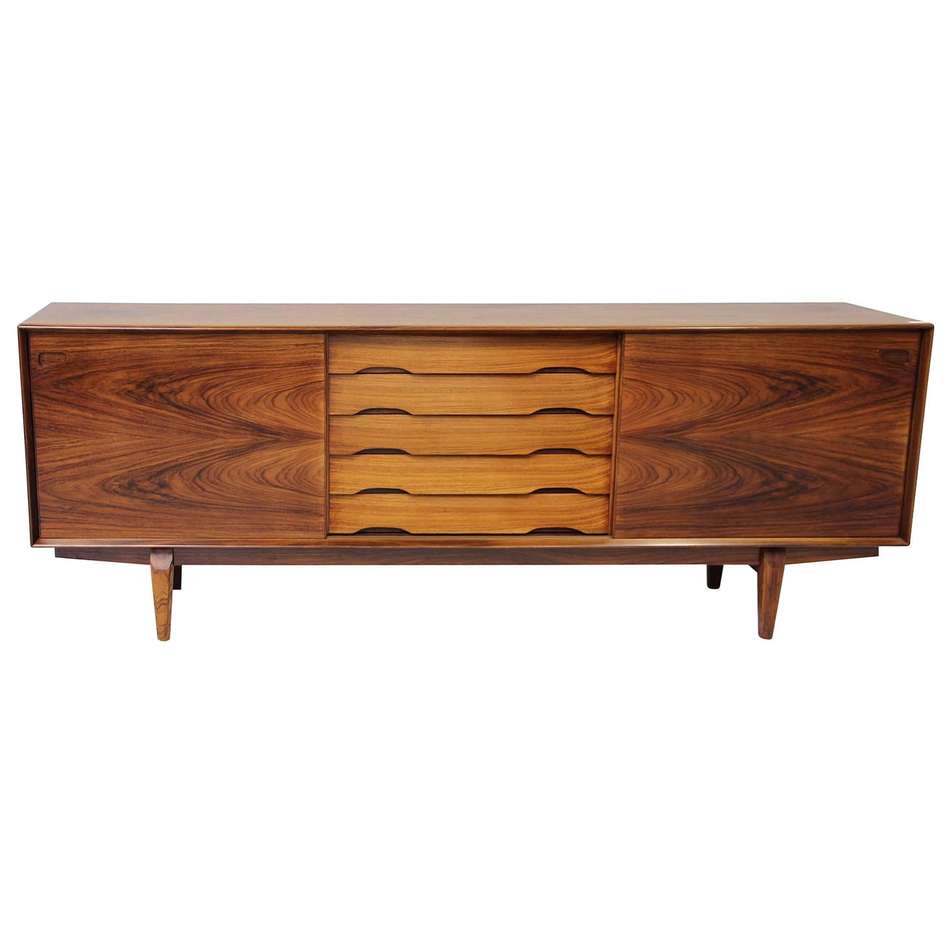 Beautiful Danish midcentury No. 65 sideboard by Skovby Mobler. In beautiful rosewood, with five drawers and two sliding door on the front and the inside with shelves. More photos coming soon.

Measure: H 82cm, W 220cm, D 47 cm.

Ships worldwide -