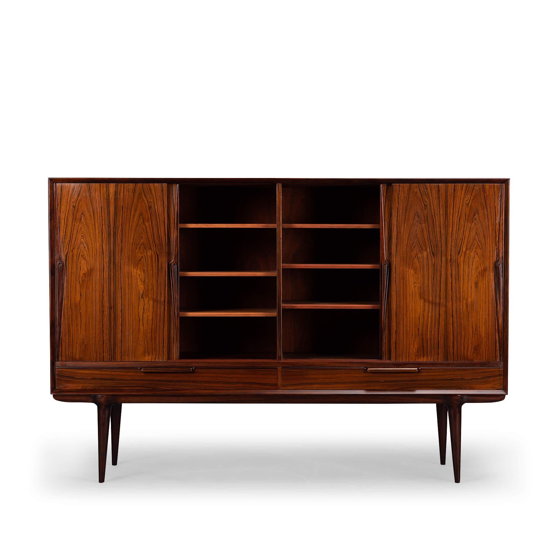 A classic among credenza's, this rosewood model #13 credenza designed by Gunni Omann for Omann Jun Møbelfabrik. Recognisable design features and perfectly proportioned, with a low profile design, this piece will work well with any modern