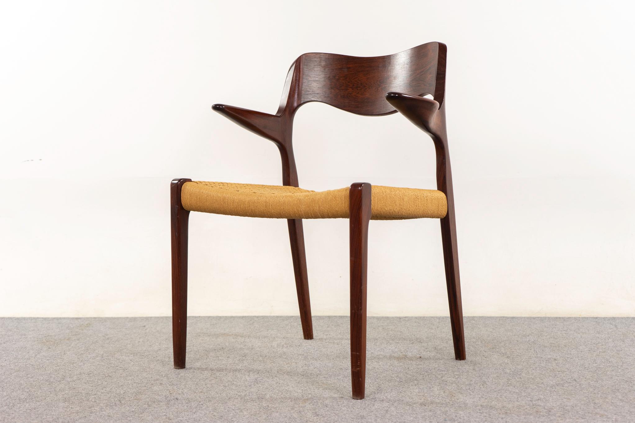 Rosewood model 55 armchair by Niels Otto Moller for J L Moller Mobelfabrik, circa 1950's. Iconic frame with graceful lines and sculptural floating armrests. Original paper cord seat with wear. JL Moller maker's mark is int

Please inquire for remote