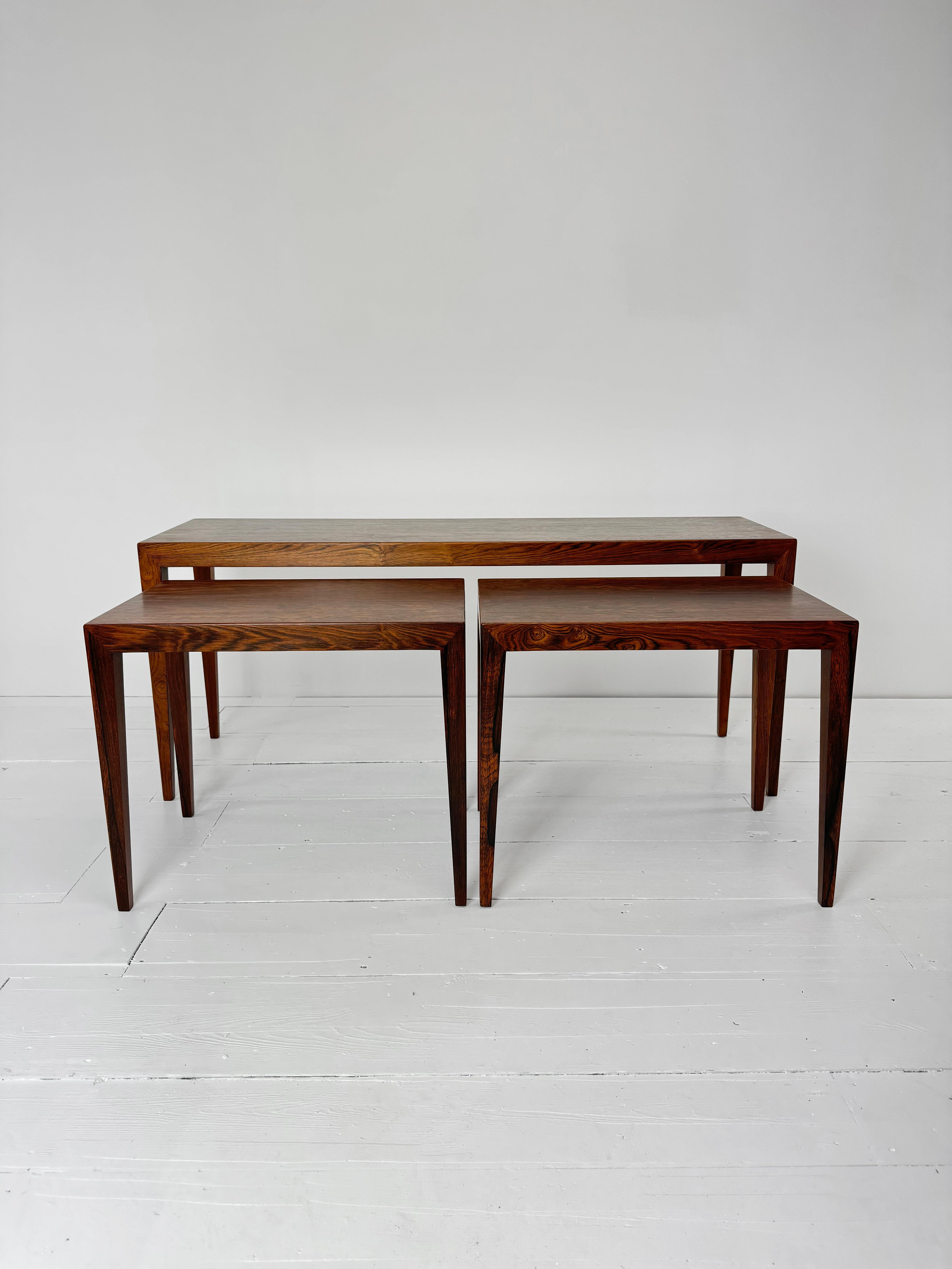 This stunning Brazilian Rosewood nesting tables set is a true vintage find, designed by renowned Danish designer Severin Hansen for the esteemed Haslev Møbelsnedkeri. Crafted from rich and exquisite Teak fame covered with Brazilian Rosewood veneer,