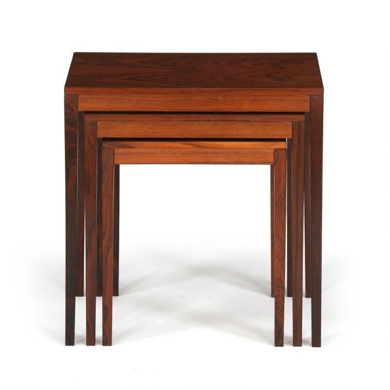 Danish furniture design: Set of three nesting tables of rosewood with slightly tapering legs. Measures: H. 52 cm. L. 50 cm. W. 36 cm. Normal patina due to age and use, including scratches and marks. Small table with paint marks.