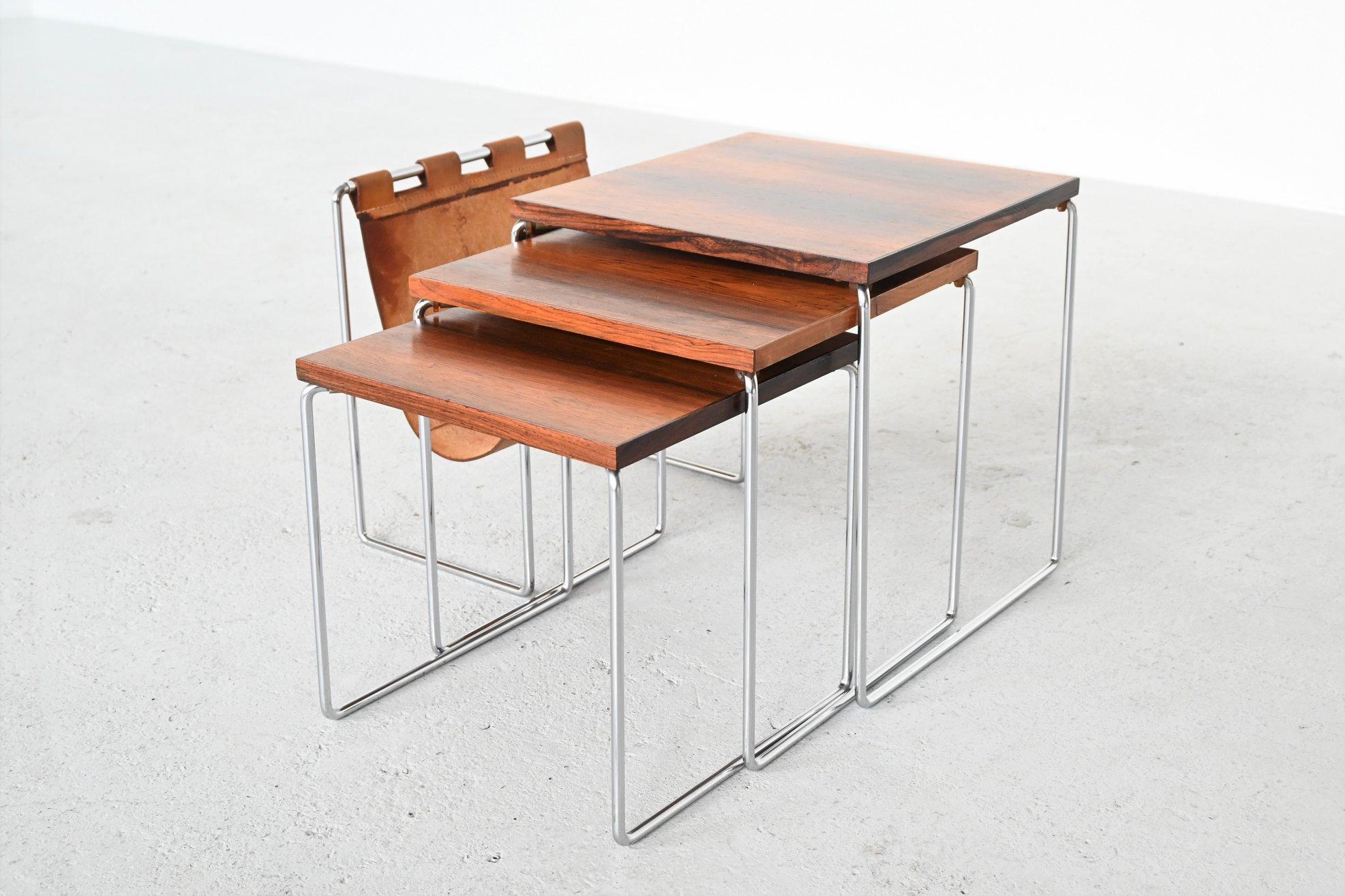 Beautiful set of three nesting tables by unknown designer or manufacturer, The Netherlands 1960. These tables have a chrome plated solid metal sled frame, nicely grained rosewood veneered top and a patinated natural saddle leather magazine basket.