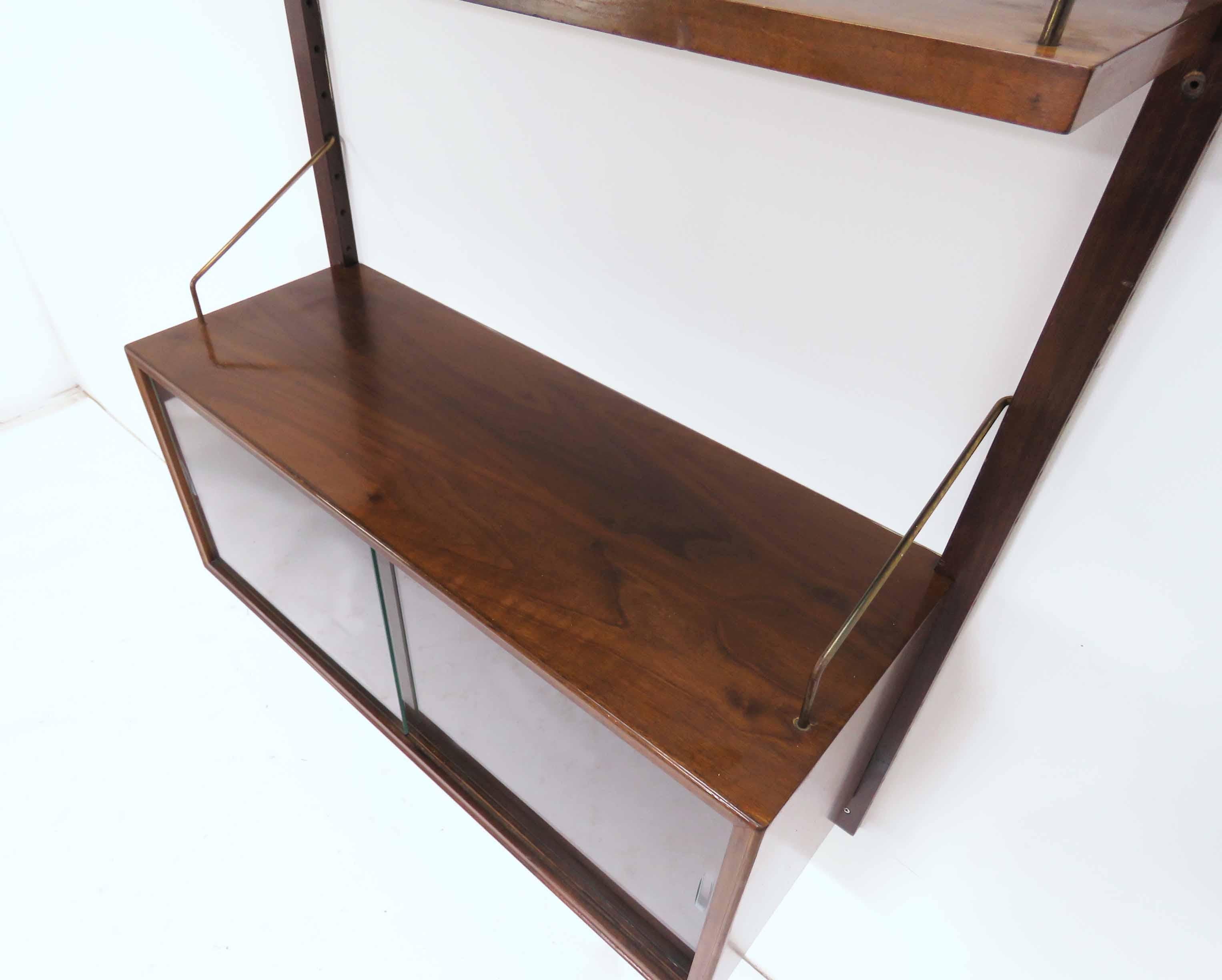 Rosewood single bay wall-mounted Royal System shelving unit, by Poul Cadovius, Denmark, circa 1960s. Consists of a single cabinet with glass doors (and interior glass shelf), and two adjustable rosewood shelves, one 7 7/8