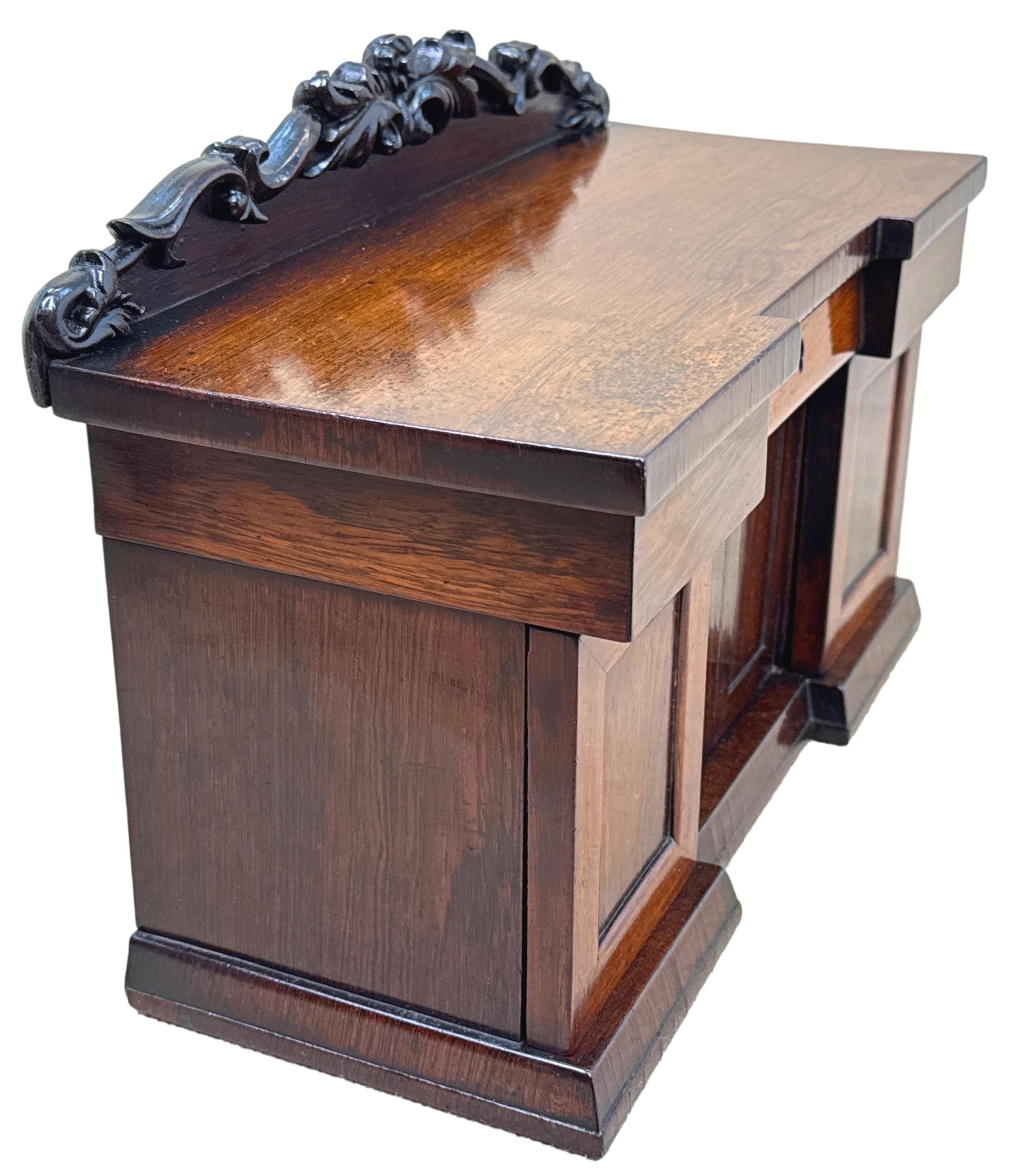 An Extremely Unusual And Rare 19th Century, Late Regency Period, Rosewood Tea Caddy, In The Form Of A Miniature Sideboard, Having Hinged Lid With Attractively Carved Back, Enclosing Two Concealed, Removable Canisters And Central Cavity, Raised On