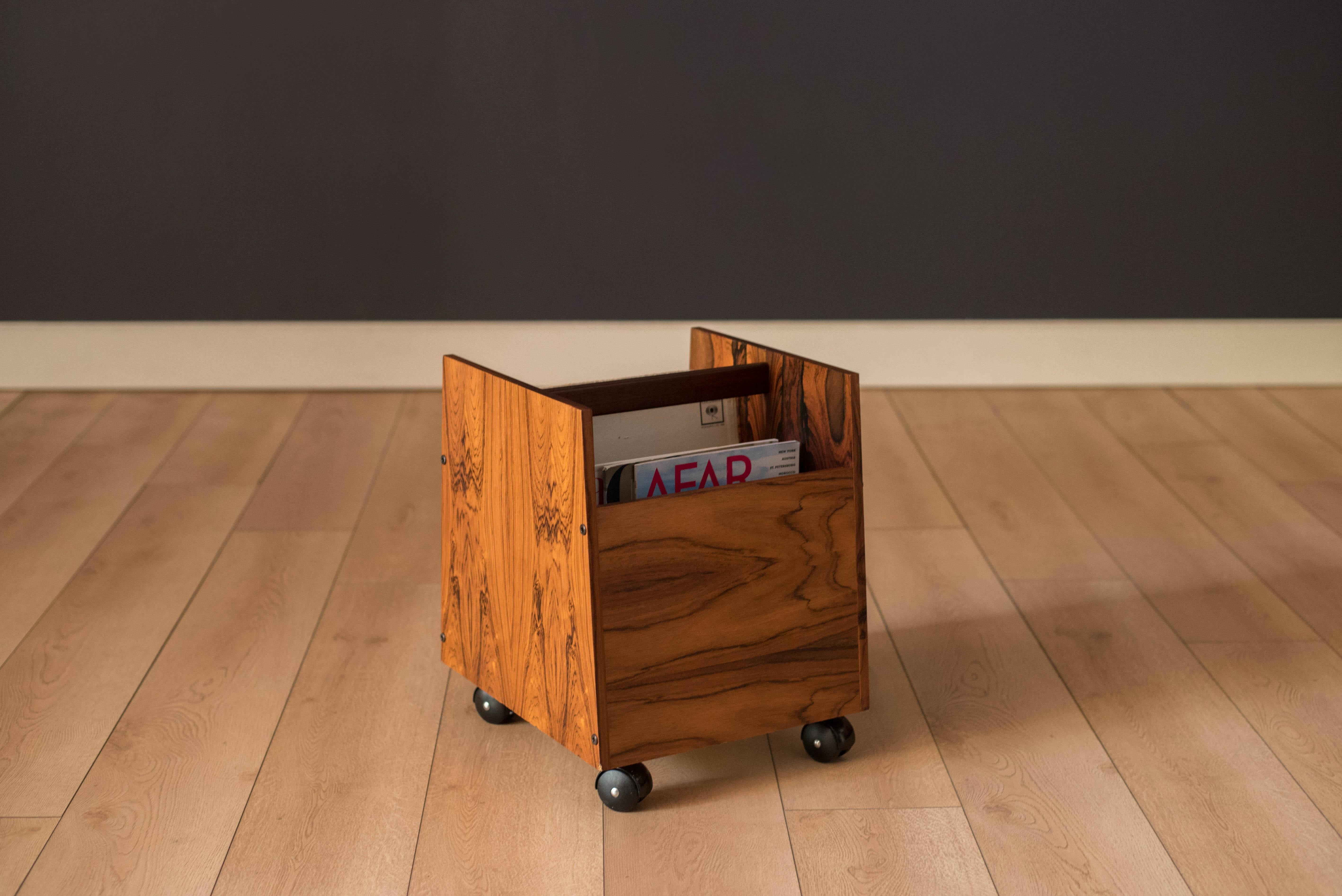 Mid-Century Modern magazine LP vinyl record storage cart designed by Rolf Hesland for Bruksbo, Norway. This piece features stunning Brazilian rosewood grains that showcase from any angle. Equipped with two removable dividers and four casters that