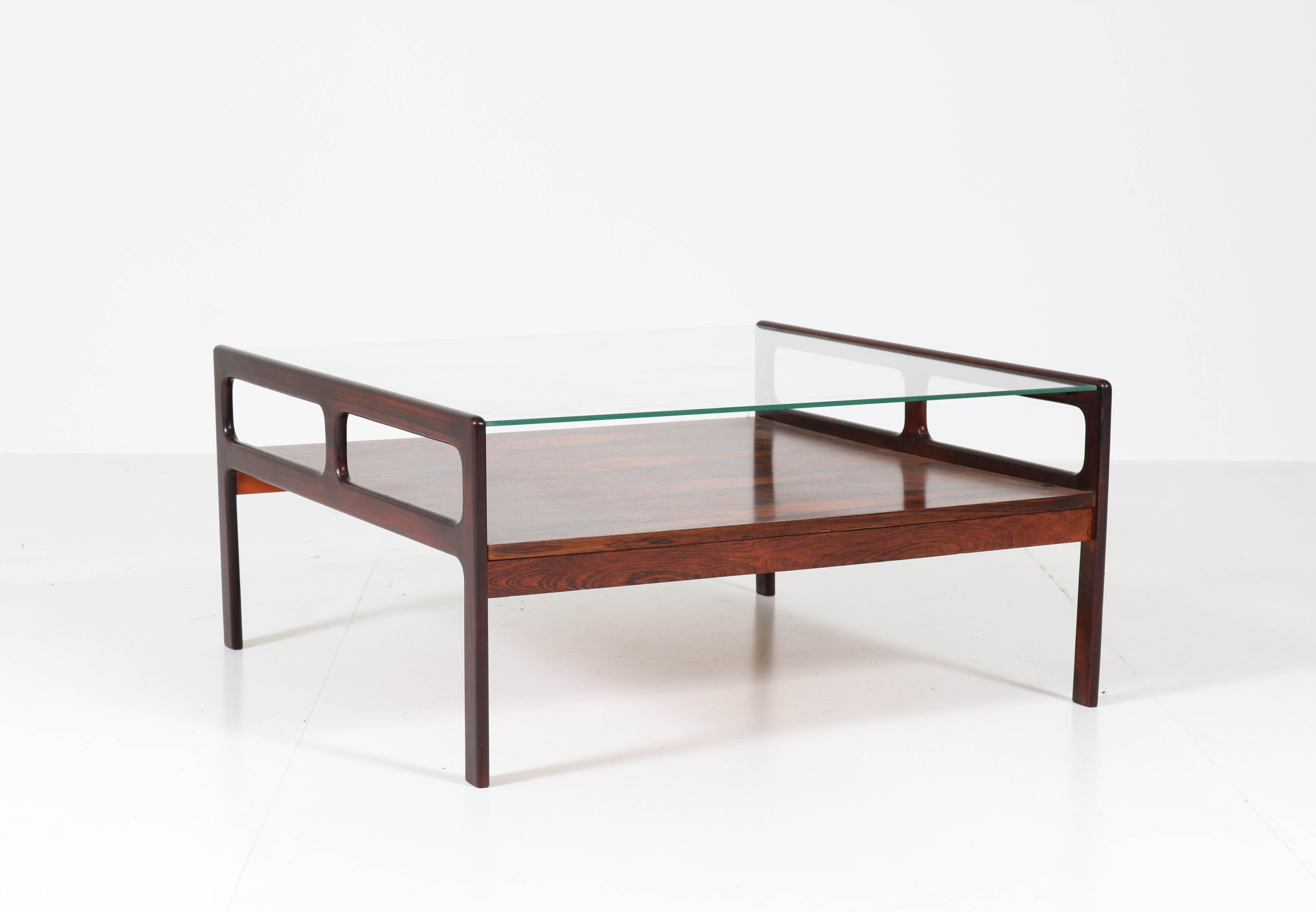 Wonderful Mid-Century Modern coffee table.
Striking Scandinavian design from the 1960s.
Rosewood base with glass top.
In good original condition with minor wear consistent with age and use,
preserving a beautiful patina.