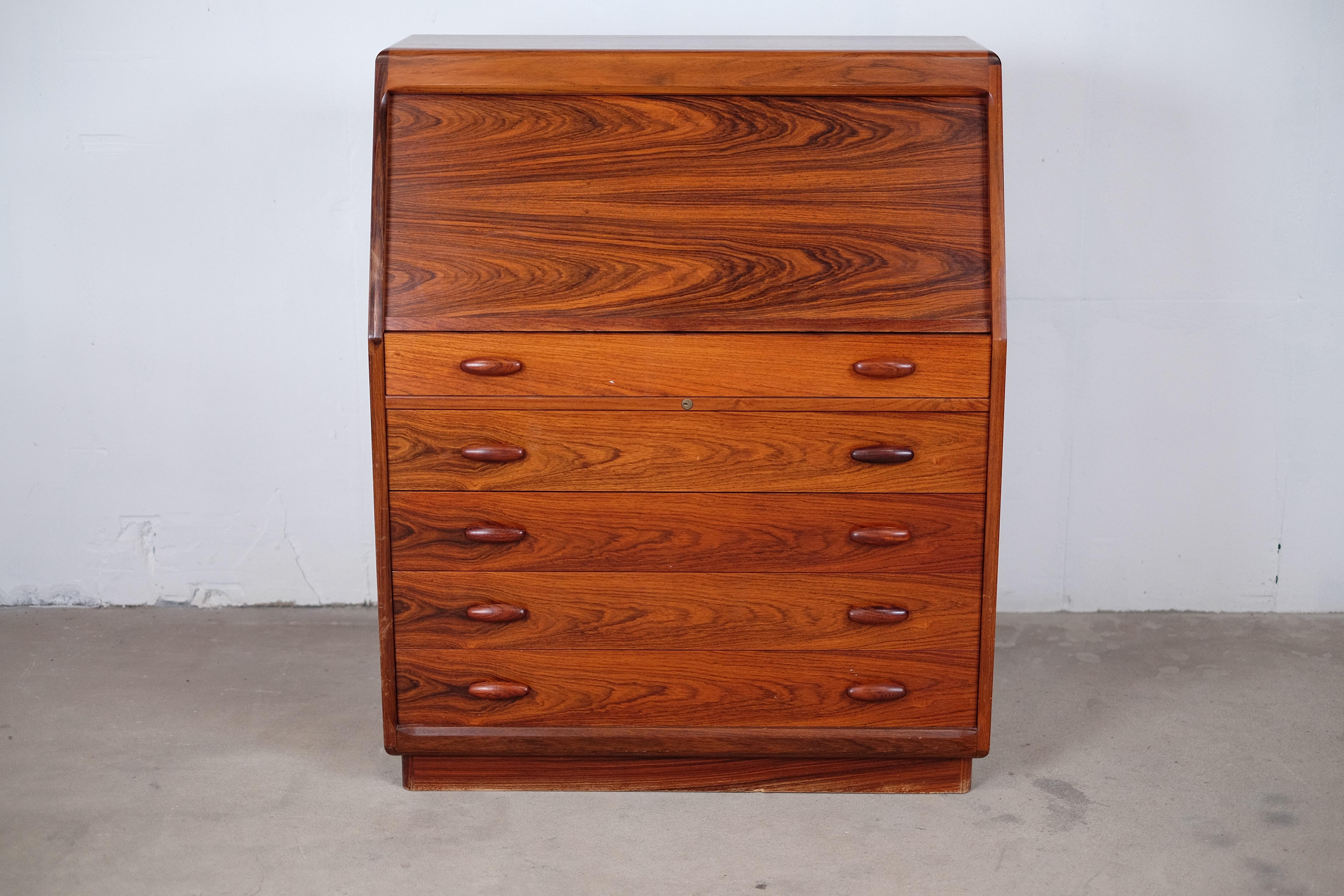Take a look on this beauty! 

This incredible rosewood secretaire features an amazing wood grain and some excellent details. The top of the five large drawers conceals a hinged mirror. When opening this drawer, the cover of the front compartment