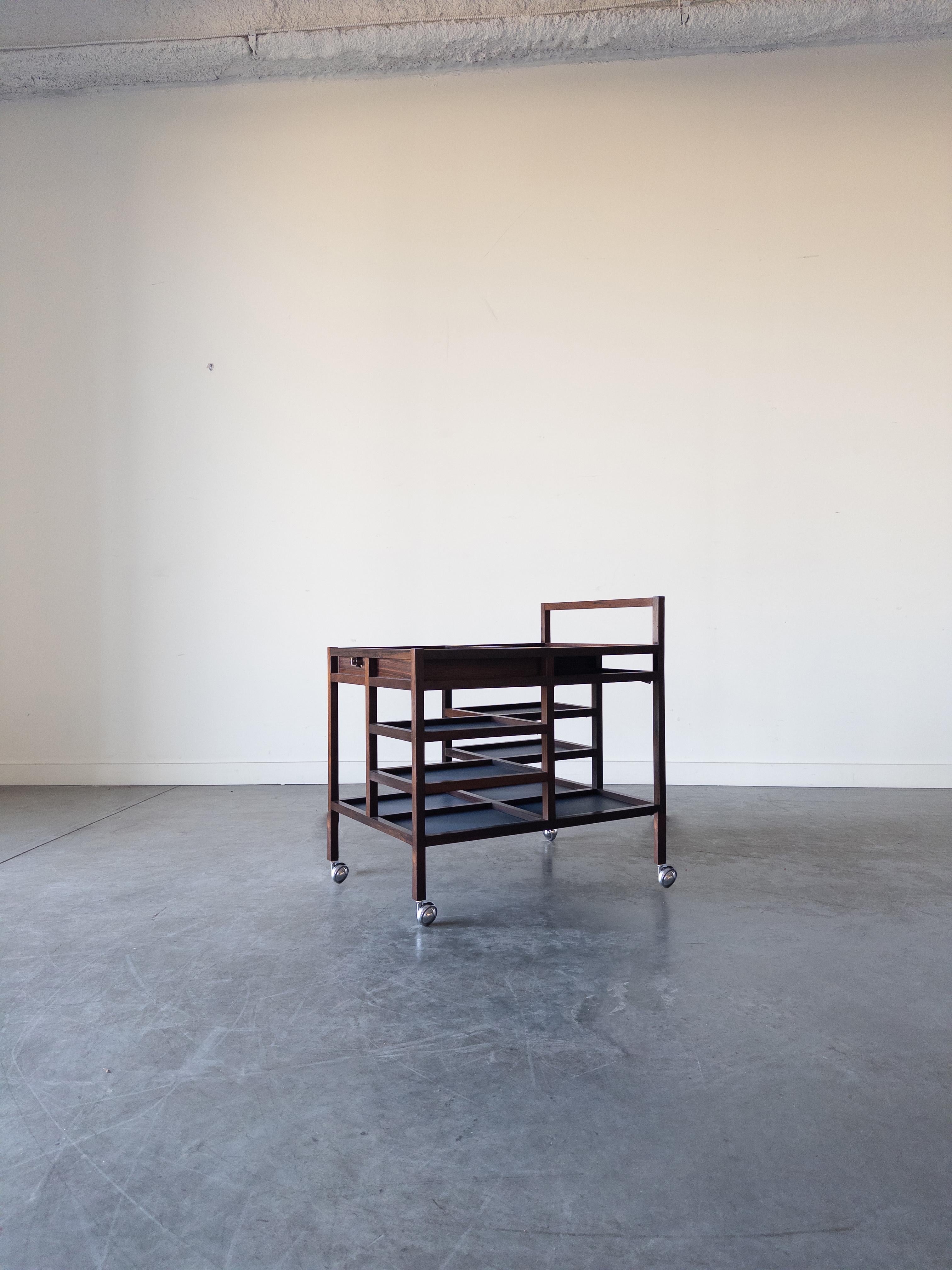 1960s Danish rosewood serving trolley by Bodil Kjaer for E. Pedersen & Son. With eight shelves, hidden drawer, metal serving surface and fully functioning.

