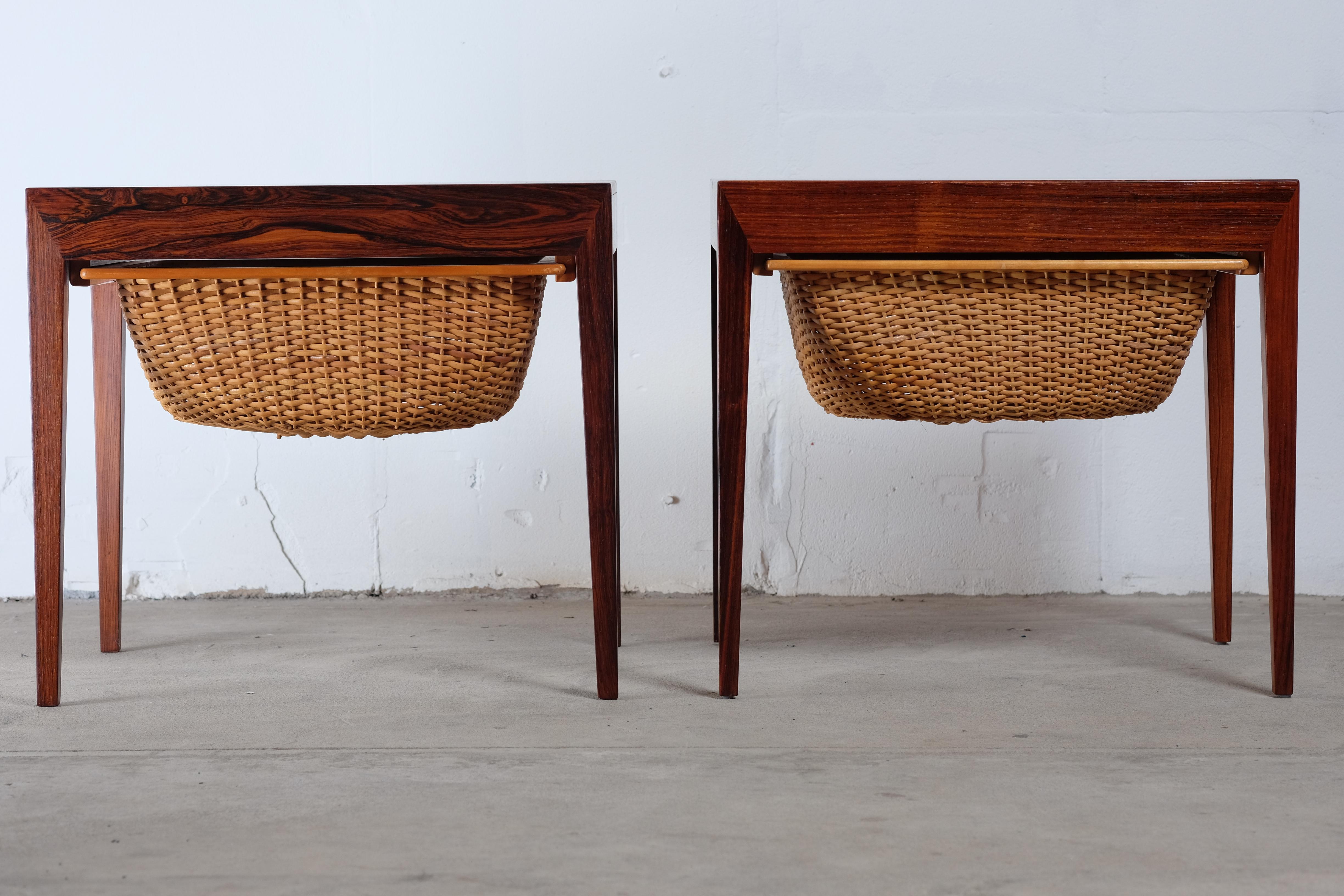 A charming pair of sewing / side tables by Severin Hansen Jr. for Haslev Møbelfabrik. It has a large basket underneath that slides out for wool or yarn storage. They also features a drawer that slides out of the front of the piece for needle, thread