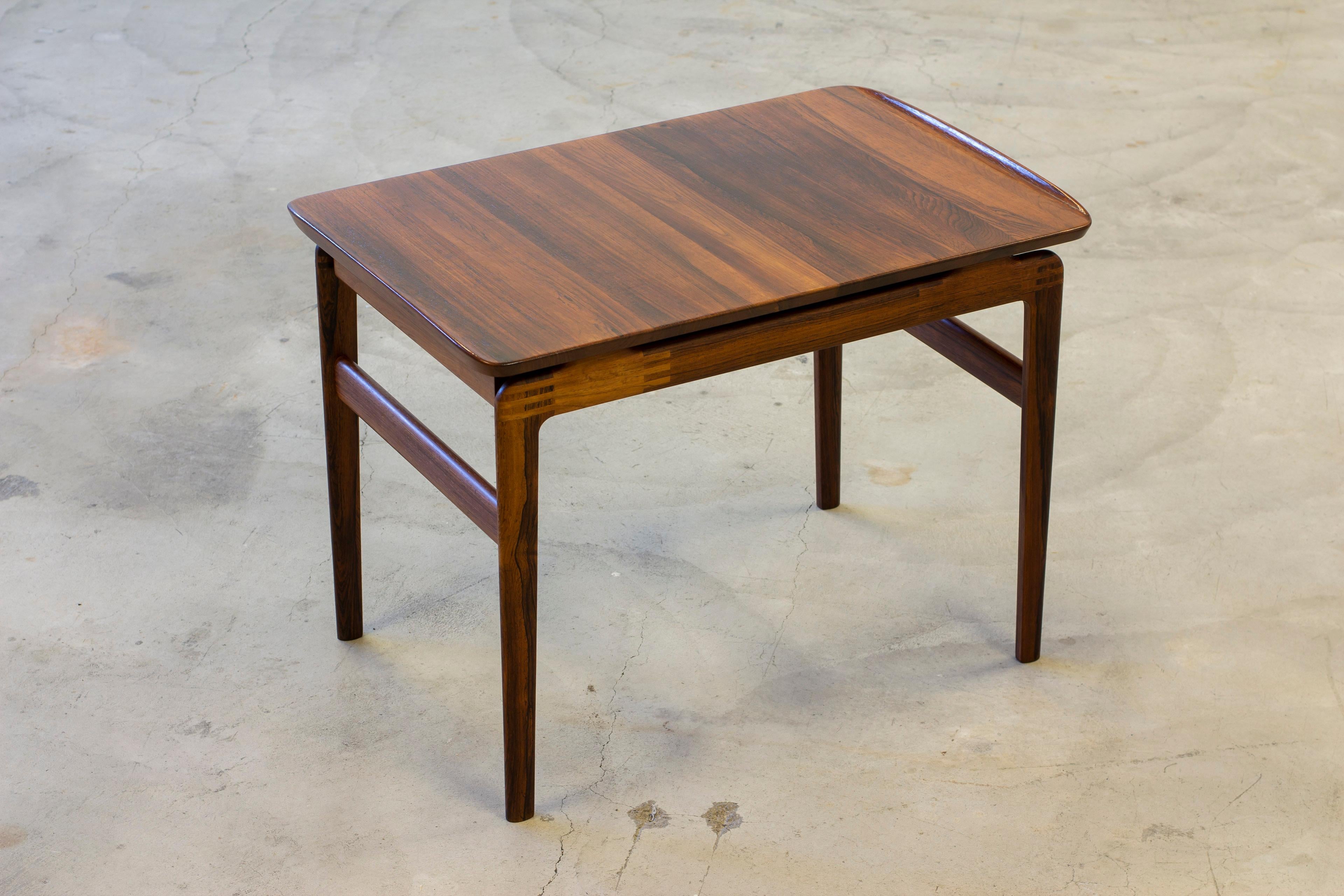 Side table designed by Peter Hvidt & Orla Mølgaard Nielsen. Produced in Denmark by France & Son during the 1960s. Made from solid Palisander with very rich grain. Sliding drawer underneath the table top. Very good vintage condition with light age