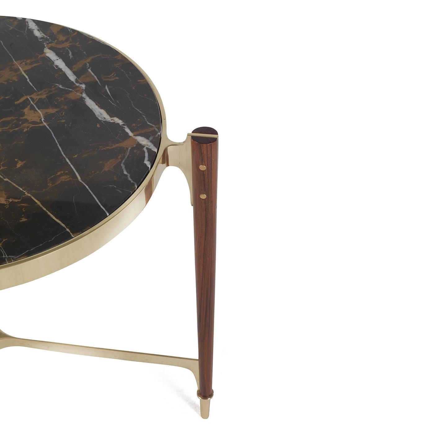 A stunning piece of functional decor, this elegant side table can be displayed alone or combined with the other different pieces by the same designer for a dynamic effect. The unique silhouette of this table, its masterful craftsmanship, and the use