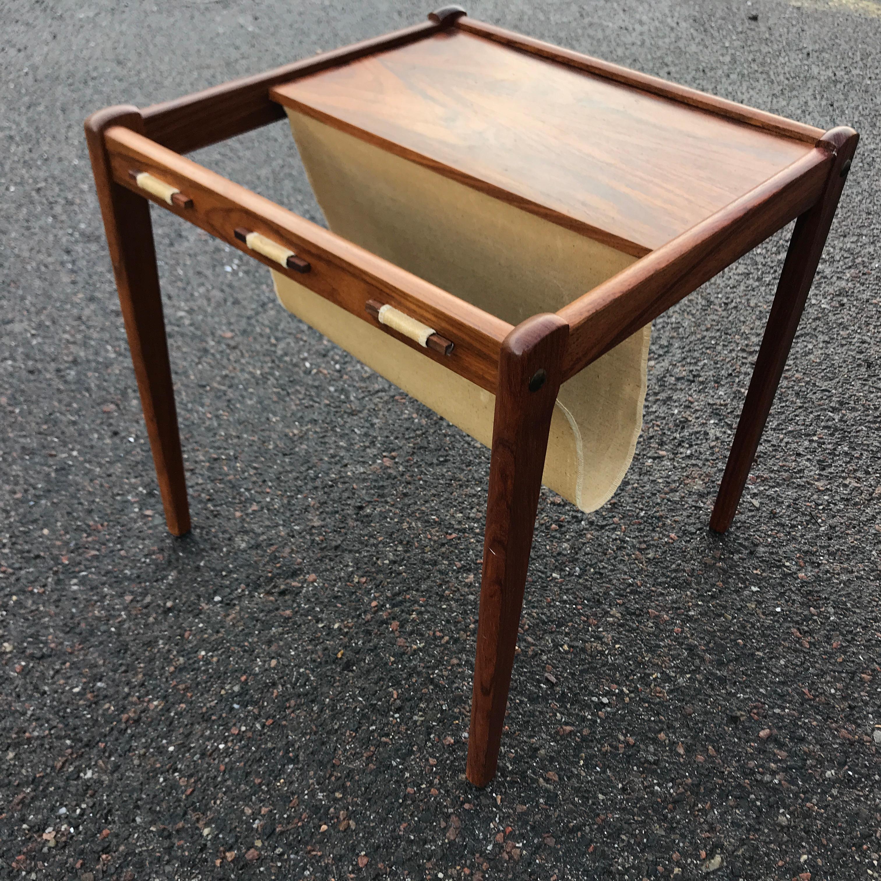 Quality craftsmanship shines through the unique rosewood finish on this elegant Mid-Century Modern side table.