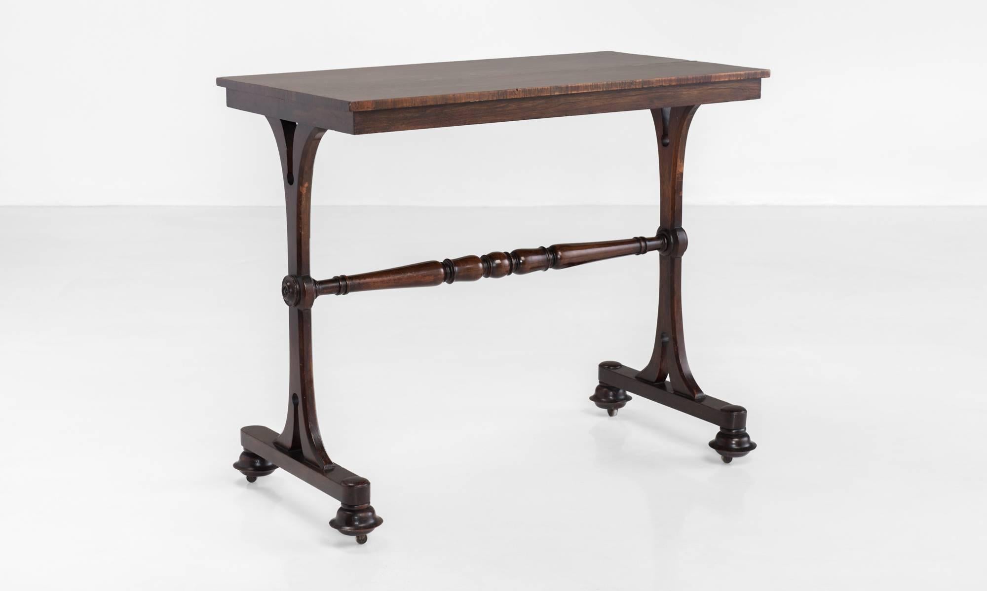 Rosewood Side Table, circa 1825

Two-plank top over a beautifully turned central stretcher connecting elegant legs on casters.