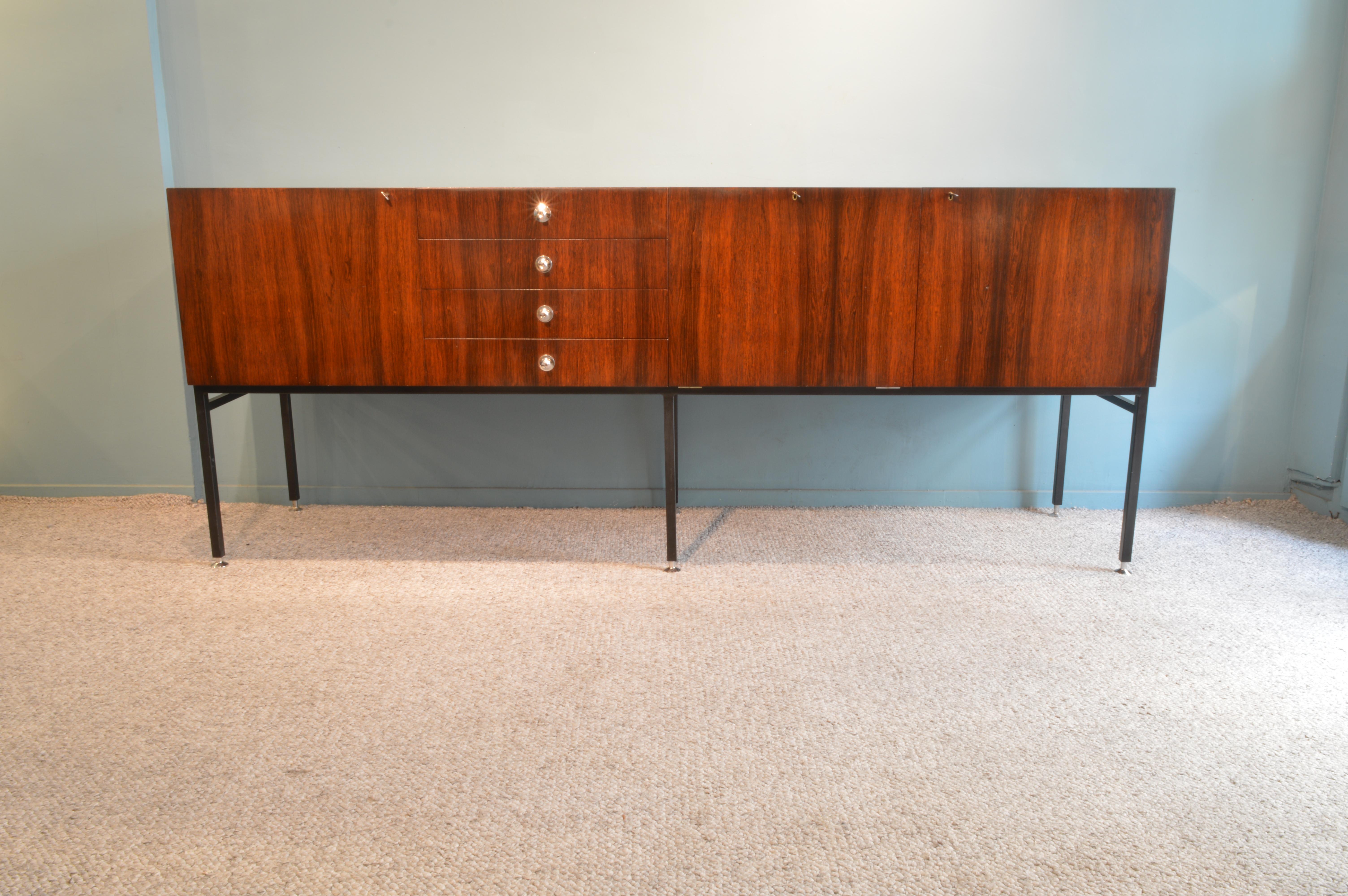 Impressive rosewood sideboard by Alain Richard.
Inside in oak wood. Adjustable feet.
French work circa 1959 manufactured by Meuble TV.
 