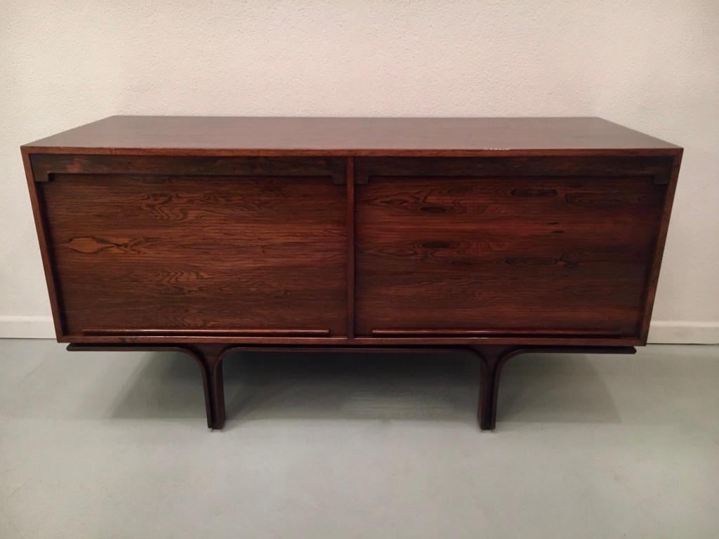 Rosewood sideboard model 502 by Gianfranco Frattini produced by Bernini Italy ca. 1957
2 cabinets with vertical tamboor doors, with adjustable shelves inside
Very good condition. The back is also finished with rosewood.
Measures: L 140 x D 53 x H