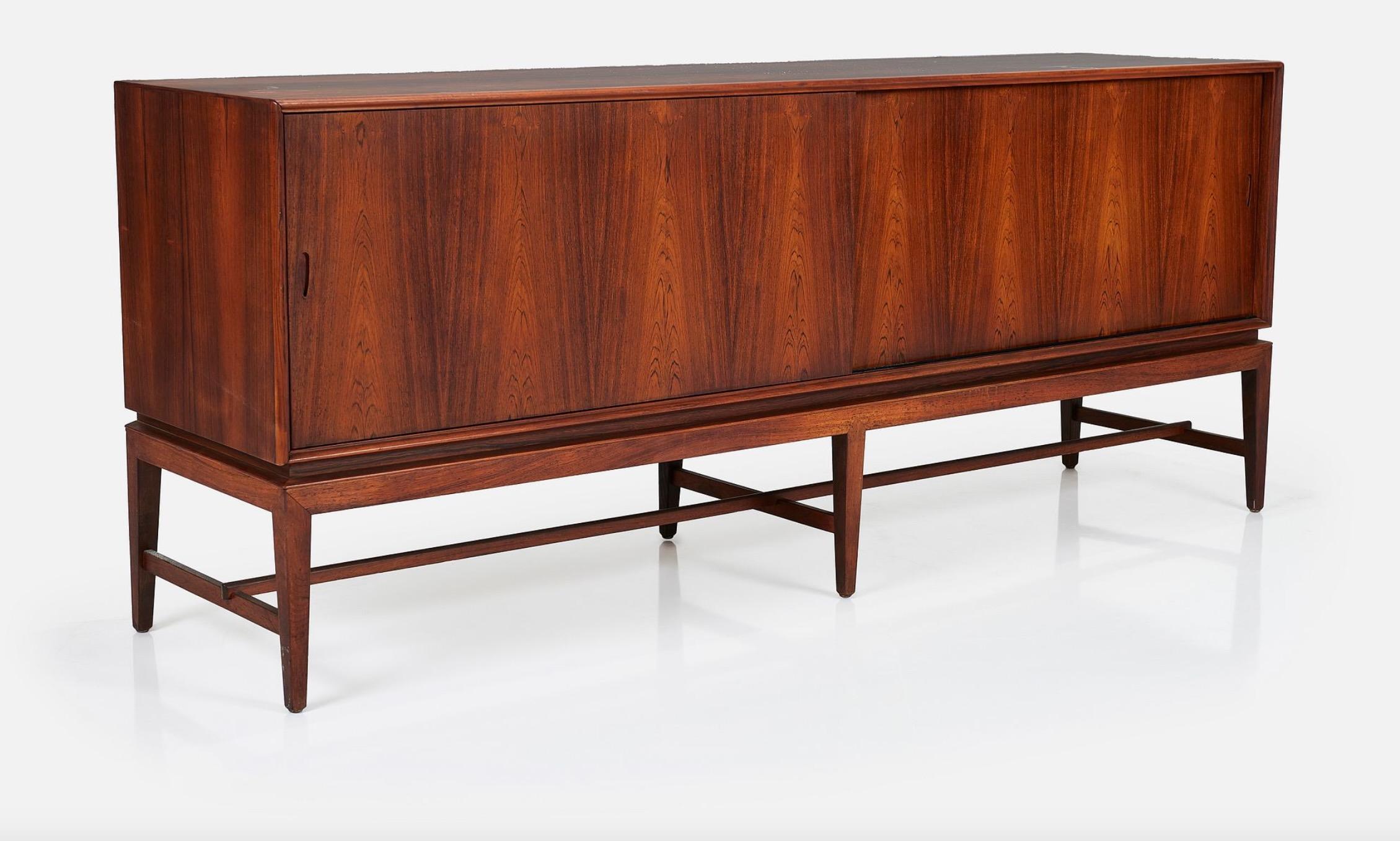 Severin Hansen Jr. rosewood credenza, c1960, Denmark.  This piece features a spacious interior with shelves and drawers concealed behind a sliding door. 
In the 1950s and early '60s, Haslev Møbelsnedkeri, a furniture manufacturer in Haslev near