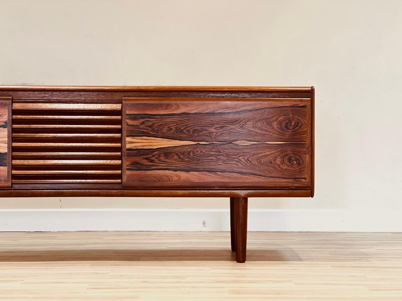 In the 1960s, Philip Hussey designed a stunning Rosewood sideboard for The Rogate collection, created for the high-end cabinet maker White and Newton in Portsmouth, England.

This sideboard is a rare find in the market. It has been entirely restored