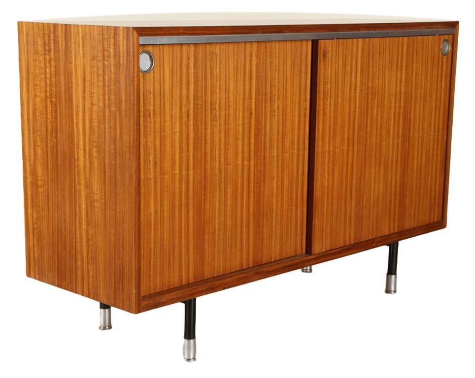 Rosewood sideboard/cabinet with two sliding doors and aluminum fittings by George Nelson for Herman Miller, circa 1968. 

Measures: H 35, W 55”, D 18.5”.

George Nelson (1908–1986) was an American Industrial designer of Modernism. While Director