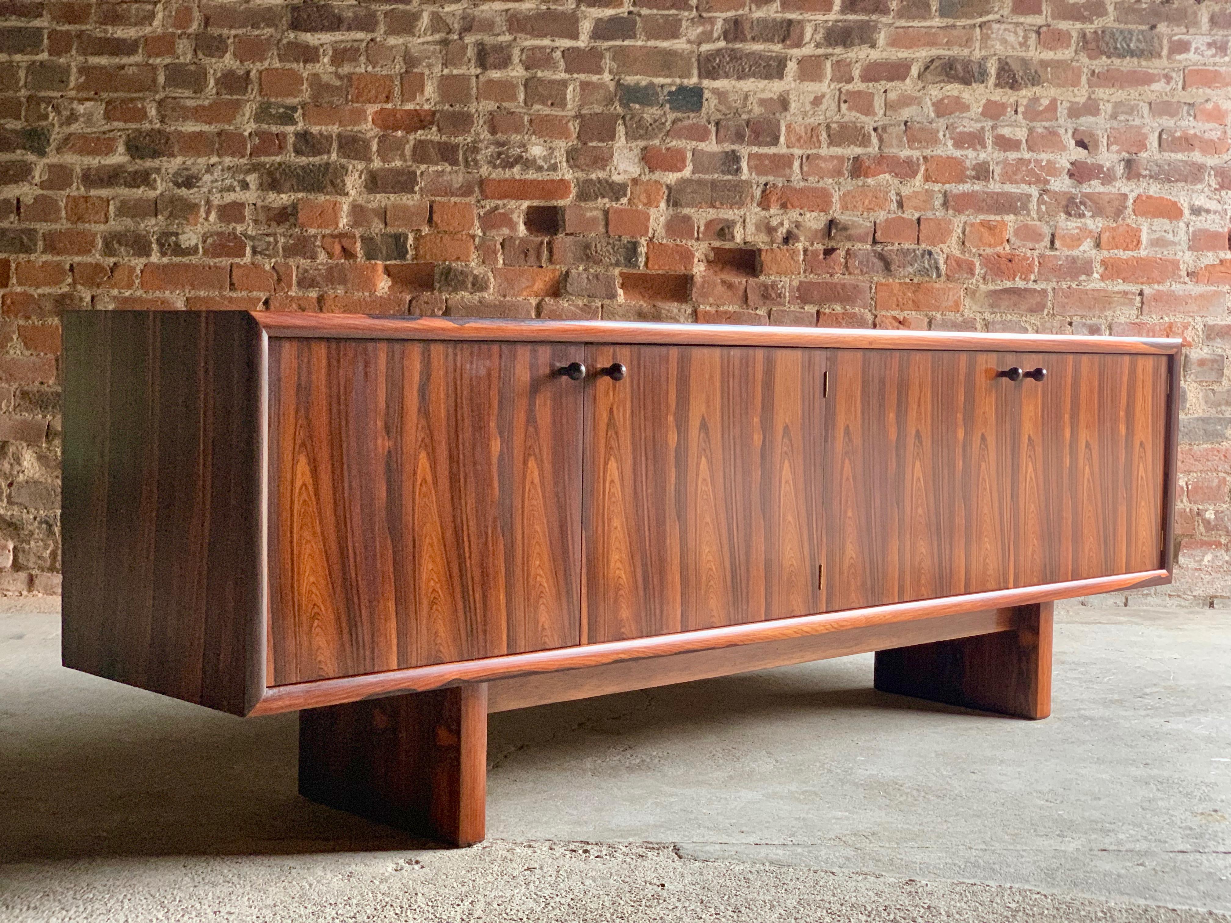 Gordon Russell 'Marlow' rosewood sideboard credenza designed by Martin Hall for Gordon Russell Ltd of Broadway, material: Figured rosewood - date: 1970s, the rectangular top with beautiful repeating rosewood pattern over four cupboard doors, shelves