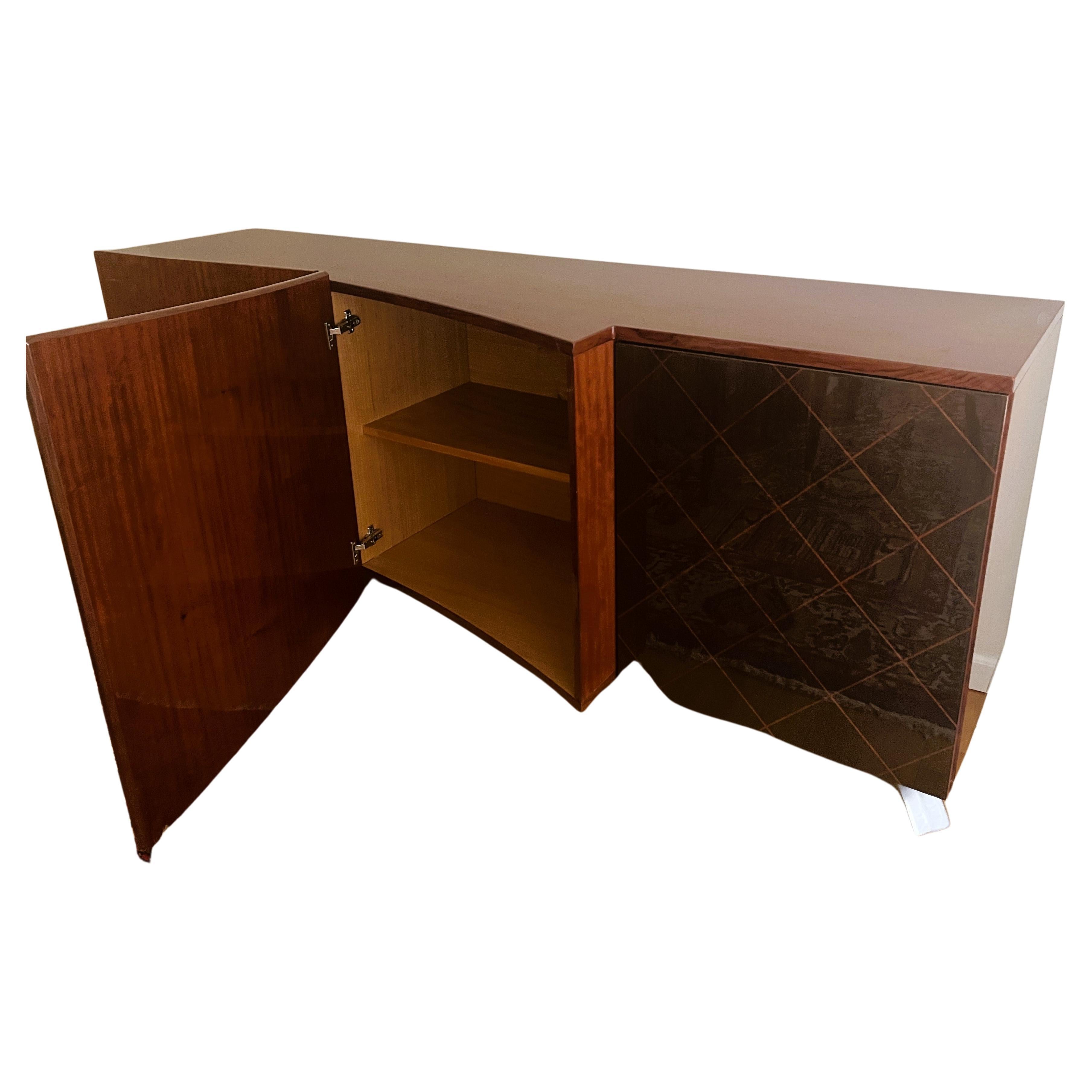 This stunning Dakota Jackson credenza made of rosewood exemplifies the best of American modern design with hints of Danish style. Crafted in Italy by skilled artisans, it boasts a generous amount of storage with three doors – two featuring