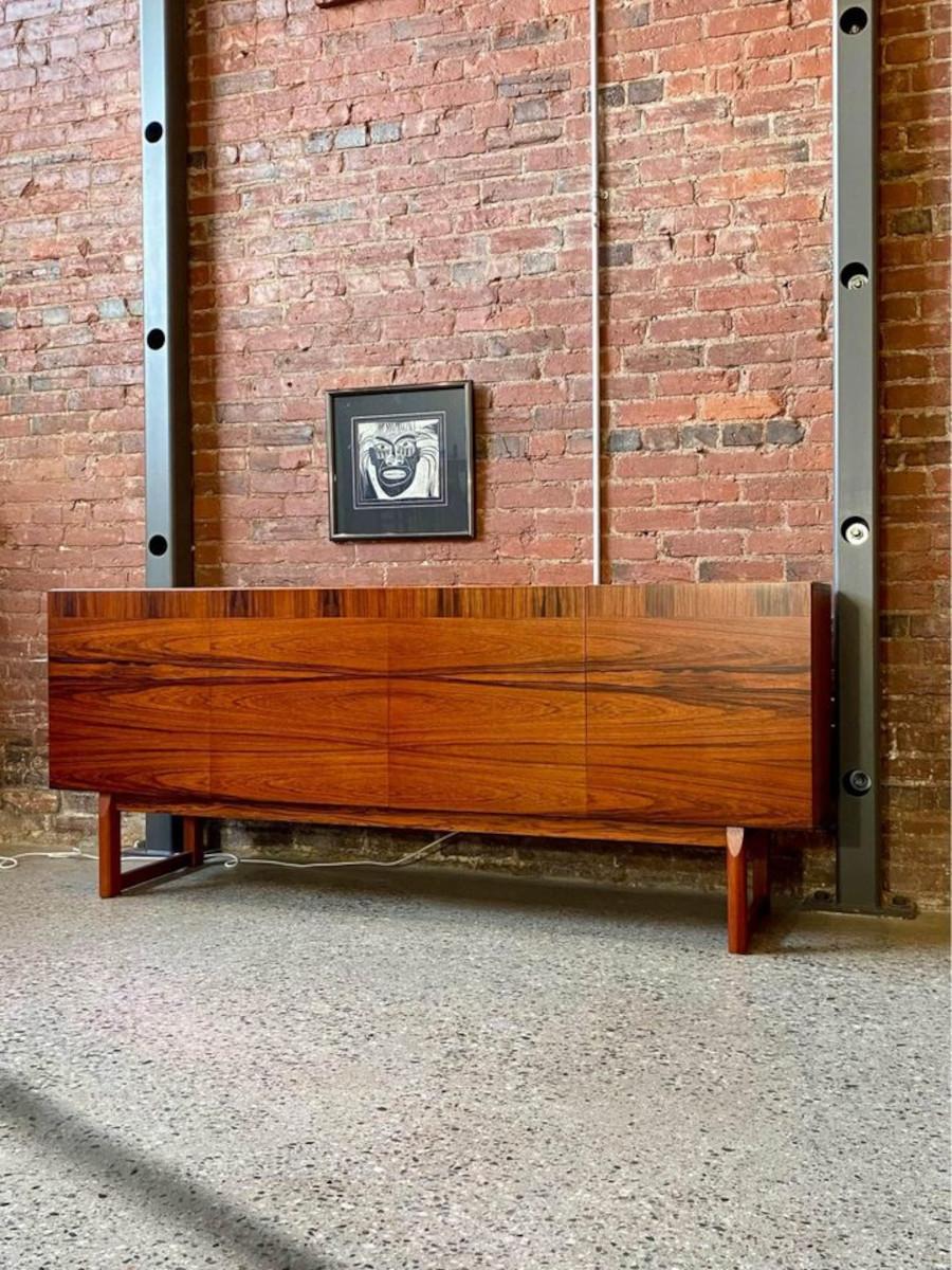 We're thrilled to present a stunning cabinet likely crafted in Sweden during the 1960s. This piece showcases intricate construction, boasting highly figured Brazilian rosewood veneer and sturdy secondary wood. Complete with two spacious storage