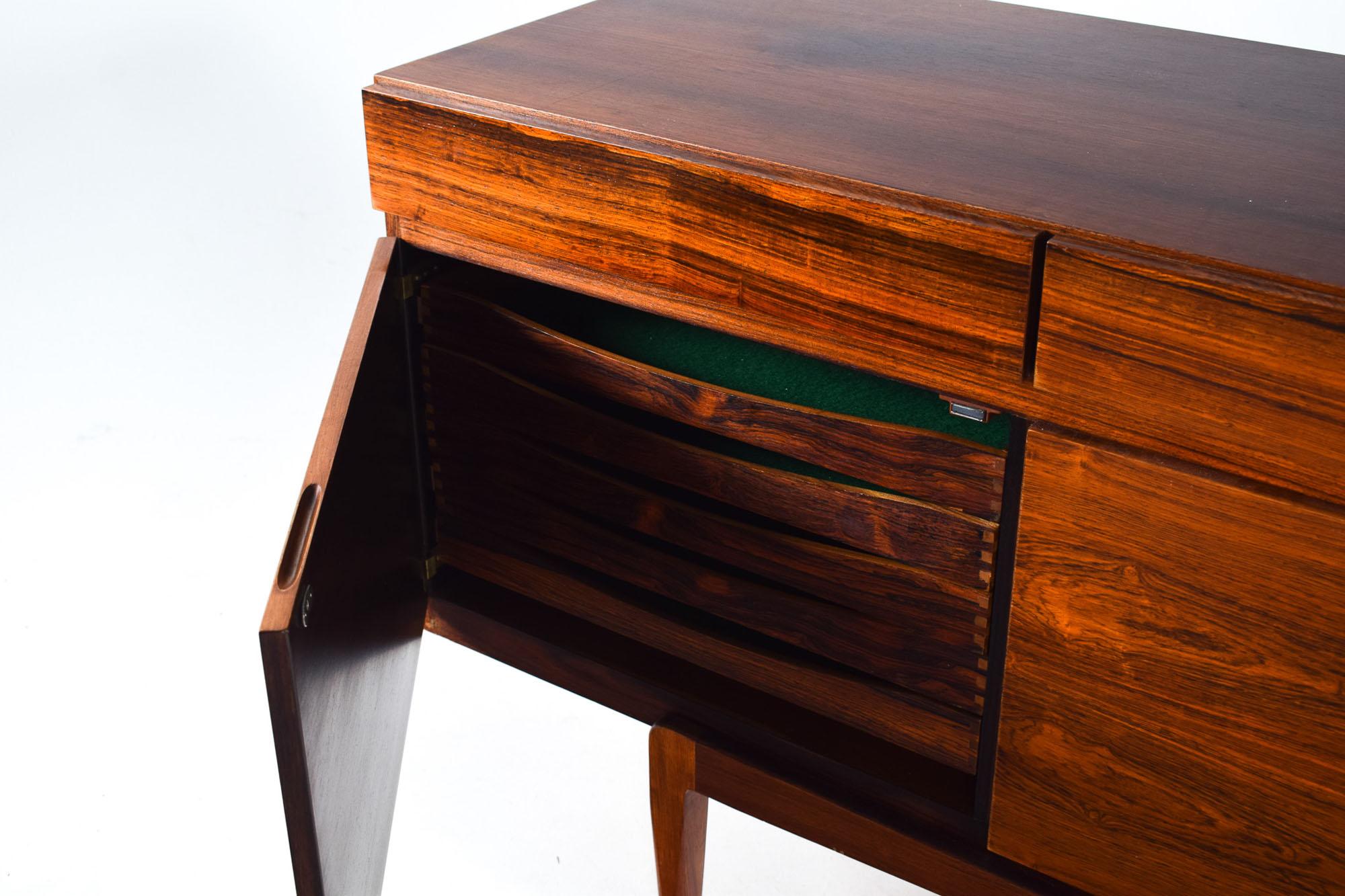 Stunning rosewood sideboard model FA66, designed by Ib Kofod-Larsen and manufactured in Denmark in the 1960s. This clean-lined sideboard features beautifully rosewood. The case sits on a raised base and offers four drawers above a four-door cabinet.