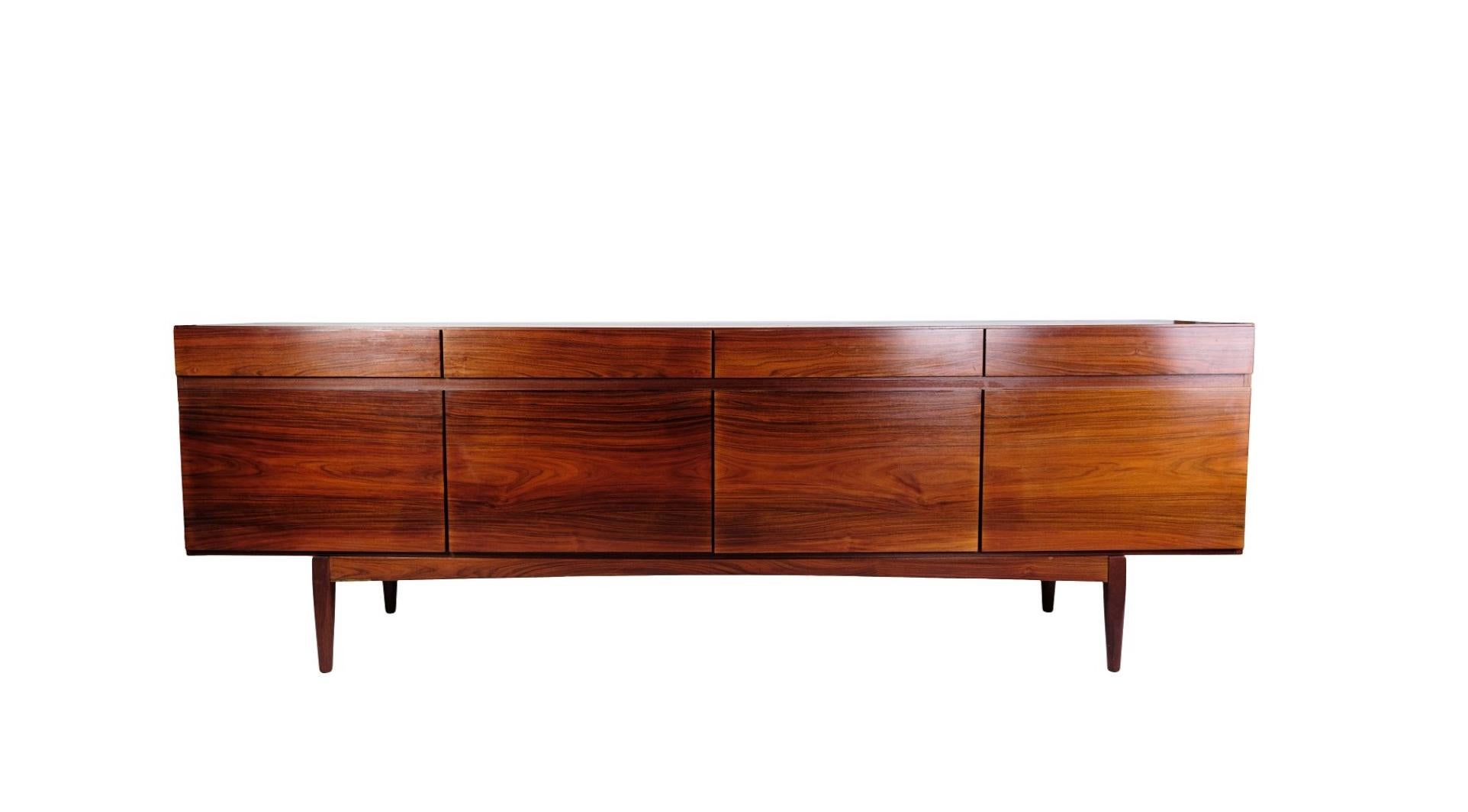 Rosewood sideboard designed by Ib Kofod-Larsen, model FA66 manufactured at Faarup Møbelfabrik in the 1960s. A low free-standing sideboard of the highest quality. It is veneered with rosewood with a very beautiful structure. In the front it has four