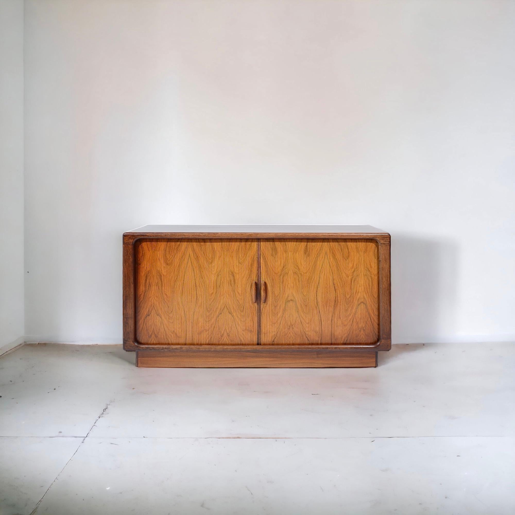 With a rounded format, this compact and chunky sideboard has a large storage volume. Its pretty sliding doors and the level of finishing specific to the firm make it an original and timeless piece. 

So many details to state! The use of rosewood in