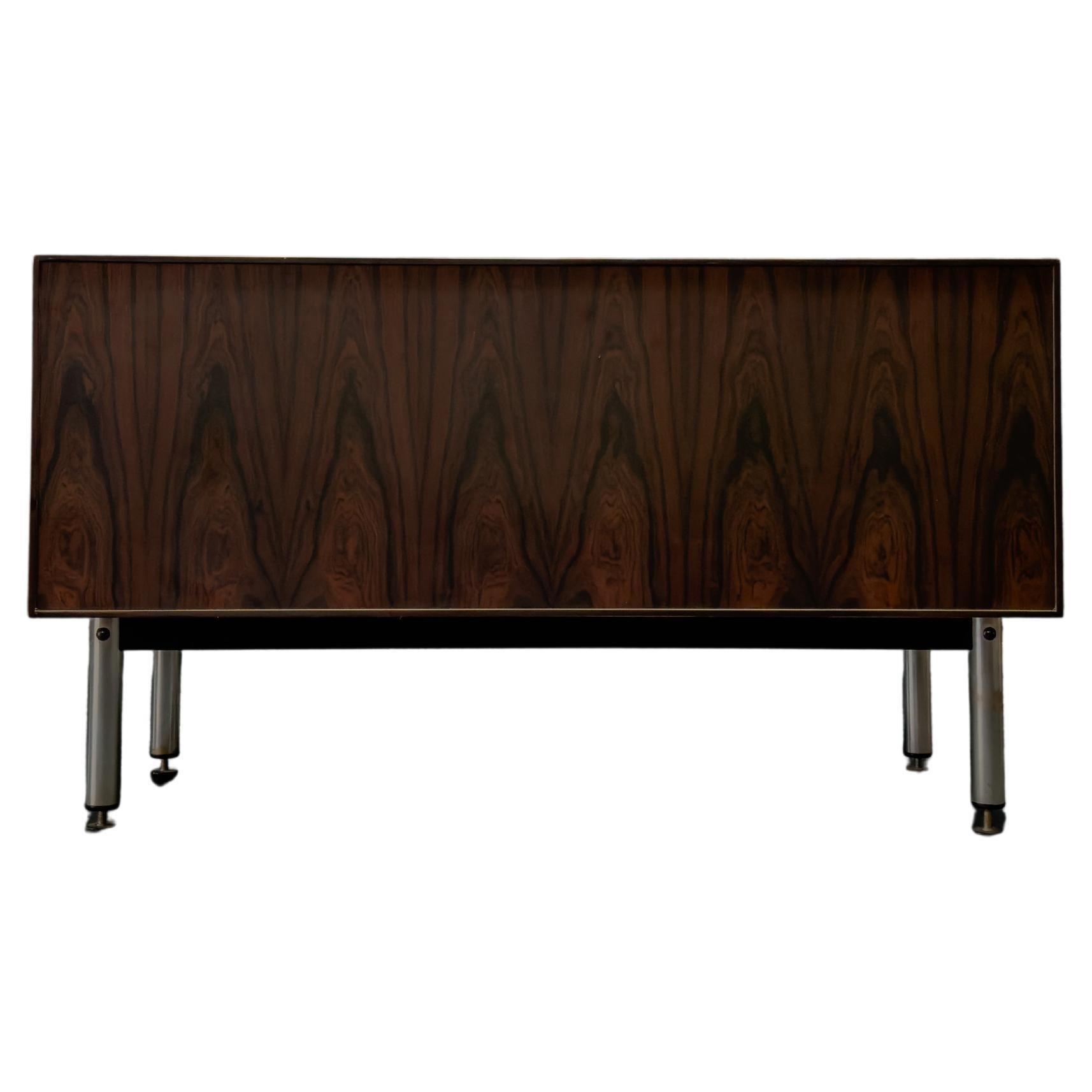 Compact in size this wonderful hardwood cabinet is a very versatile piece. Featuring sliding doors, with small inlaid curved handles for a sleek yet functional use, the doors reveal two great sized compartments with modular shelves. The interior of