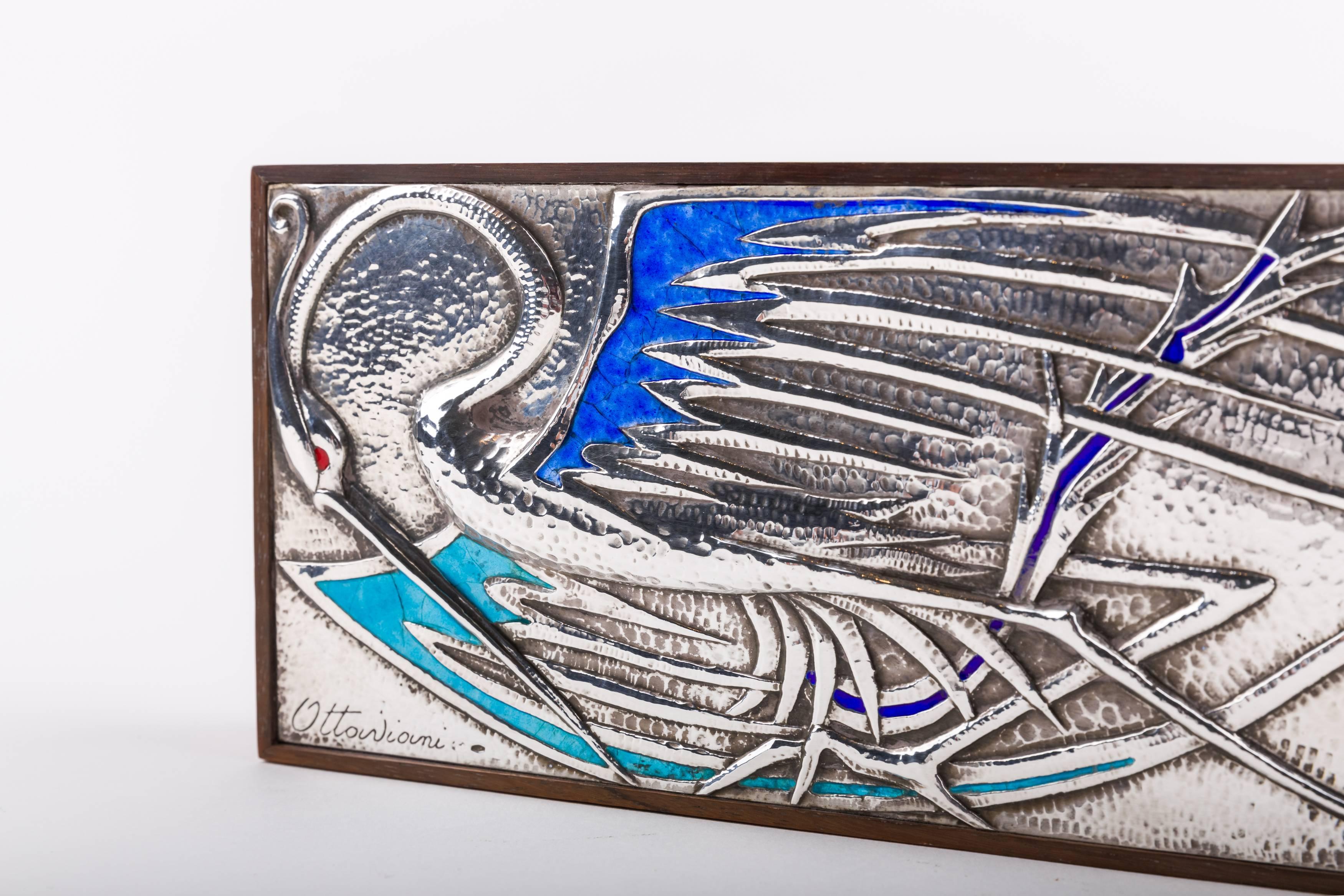Rosewood box decorated with a sterling silver and enamel plaque by the Italian silversmith Ottaviani, circa 1960s. Signed with the maker’s signature and “925”.
Notes: Ottaviani (1945-contemporary) is a jewelry and silver firm located in the small