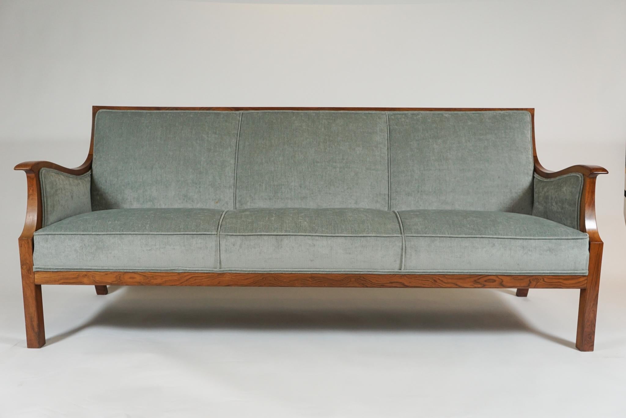 Elegant rosewood open arm sofa by Danish modern designer, Frits Henningsen from 1960s, newly upholstered in a pale blue
velveteen fabric.
