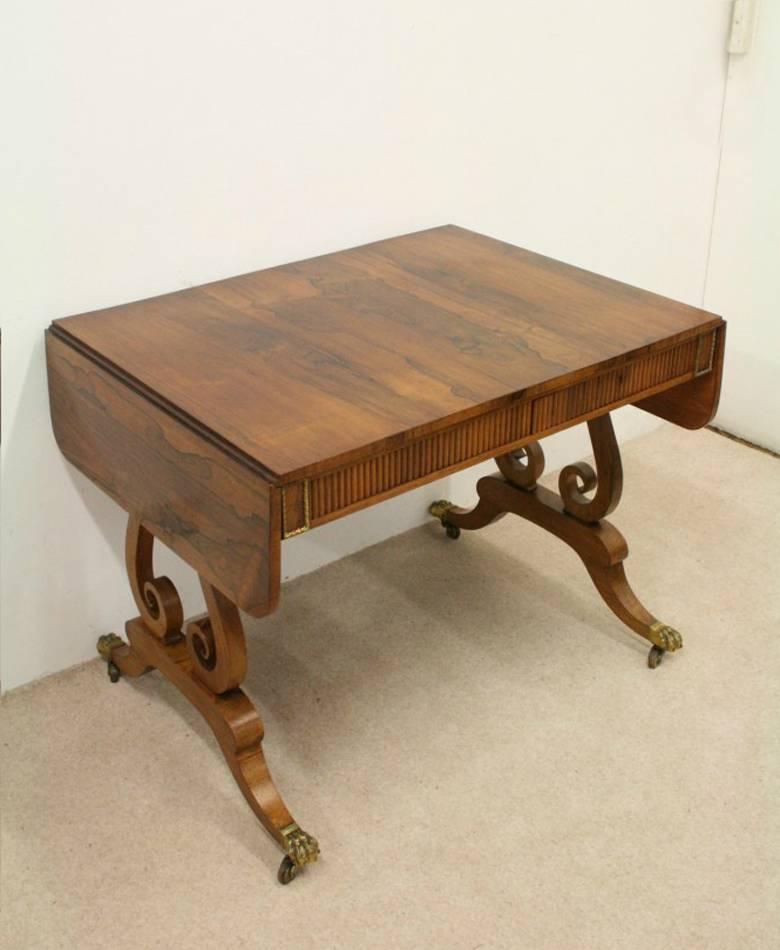A rosewood sofa table by William Trotter of Edinburgh, circa 1815. The table has a stylish rosewood top, below this there are four unusual panels with decorative gilded lead beadings on each corner of the table. There are drawers below the apron