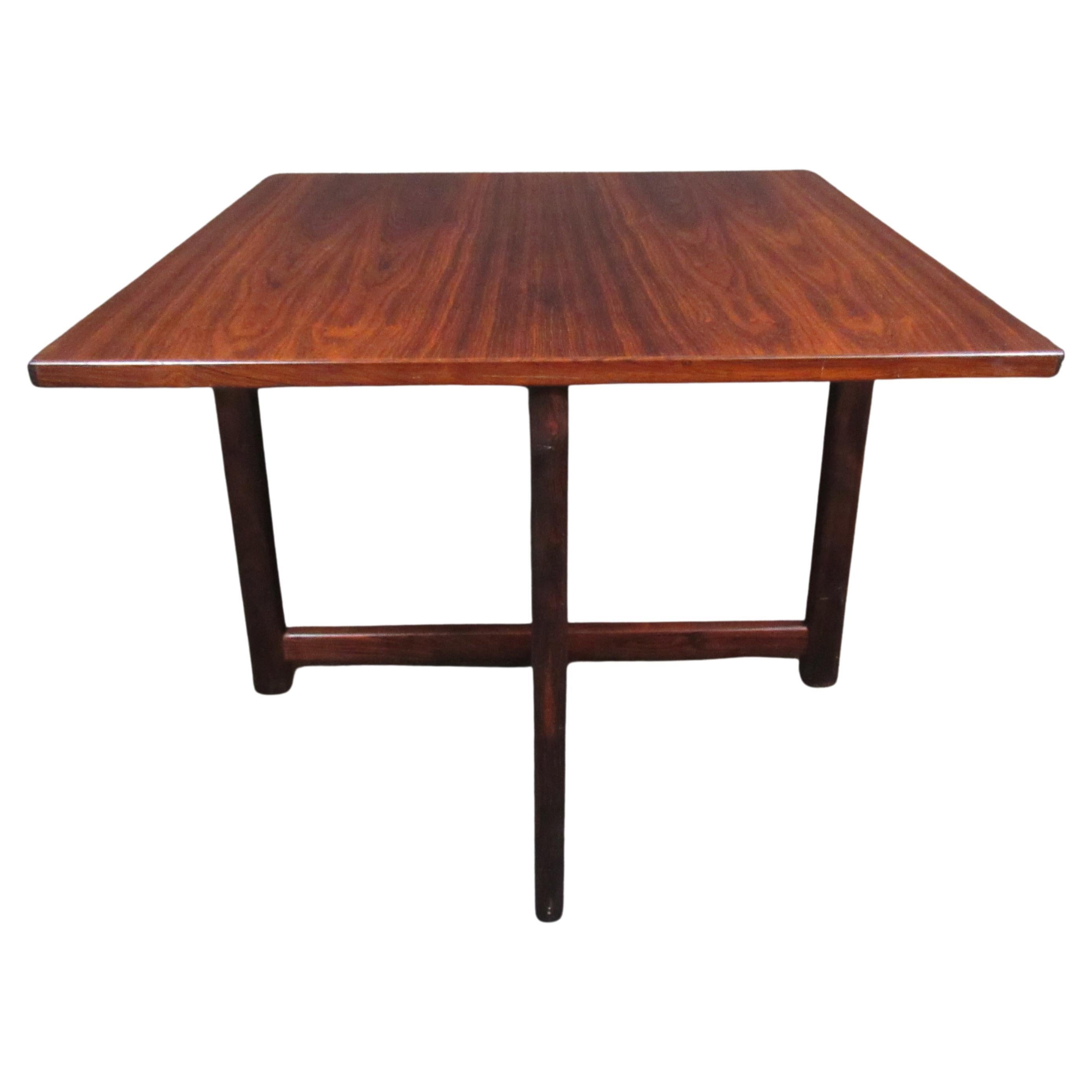 Stunning small table from Denmark's Durup Polstermøbelfabrik. A gorgeous rosewood tabletop is sure to impress with it's rich, natural grain. Crossed leg struts provide both aesthetics and stability. 
Please confirm item pickup location (New York or