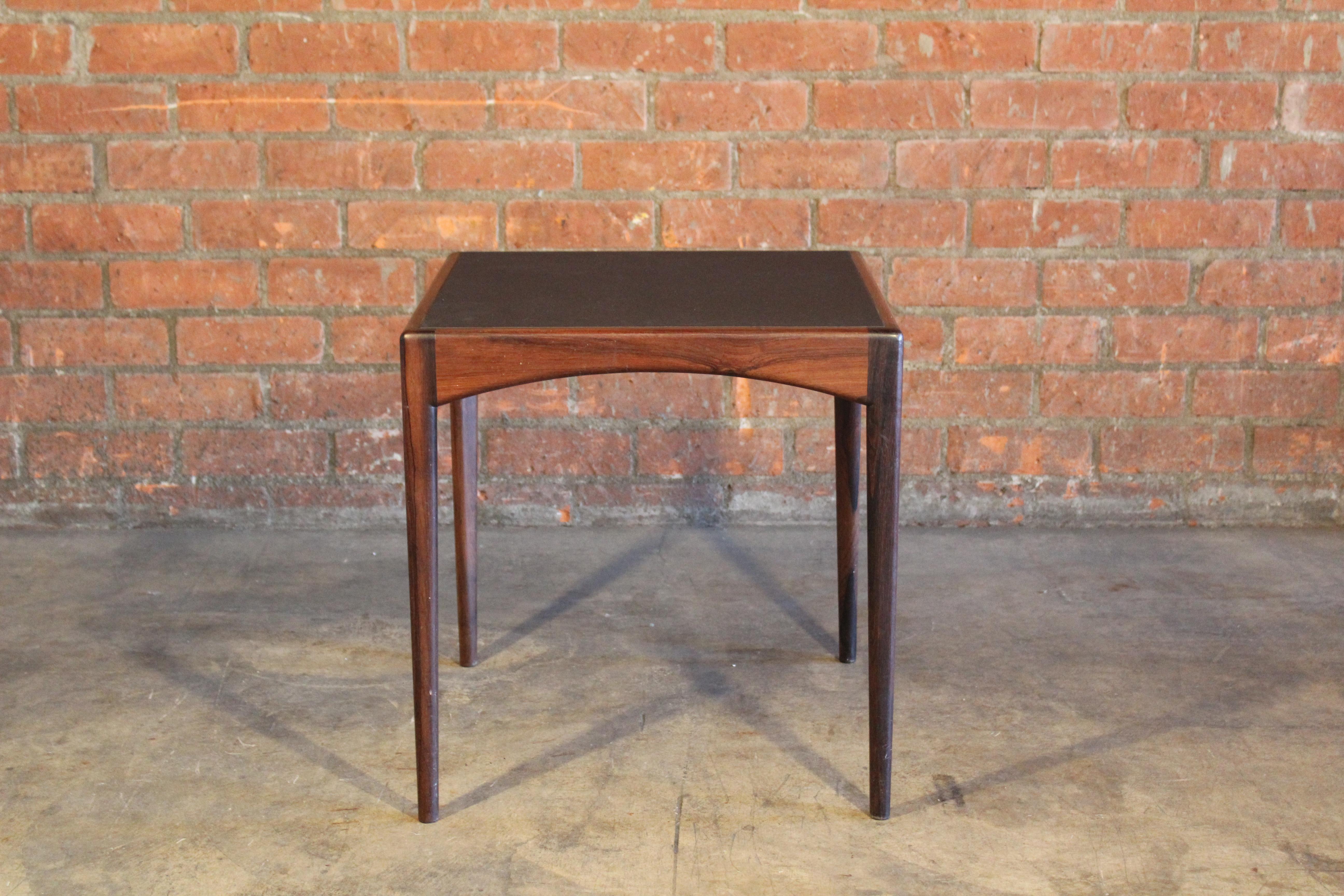 A beautiful 1950s table made of solid Brazilian rosewood with a leather insert top. Made in Denmark. In good condition.