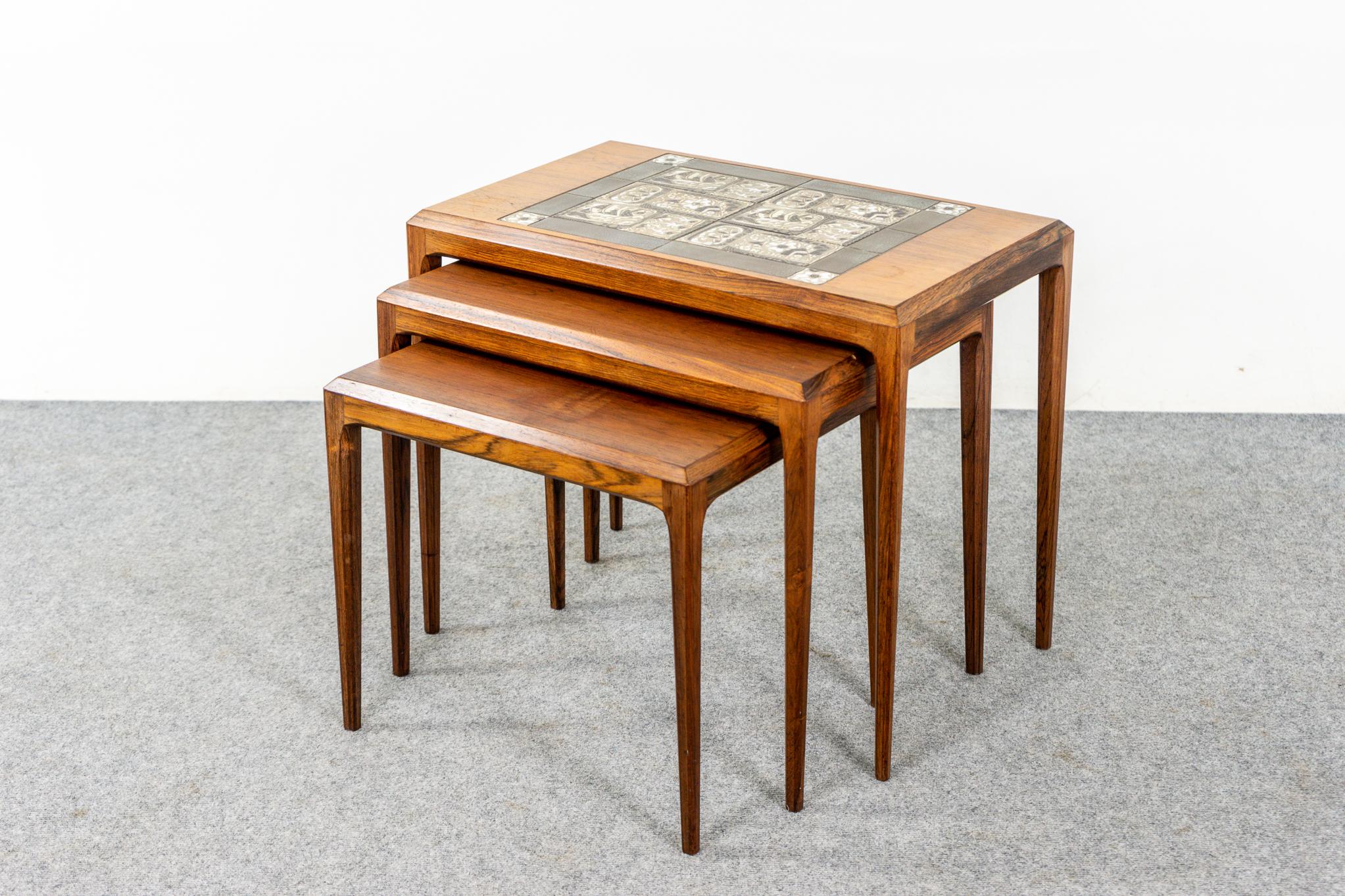 Rosewood and tile nesting tables by Johannes Andersen for Soborg, circa 1960's. Space saving design, the small footprint of one table with the functionality of three! Top table shows beautiful ceramic tiles. Clean simple design, tapered legs and