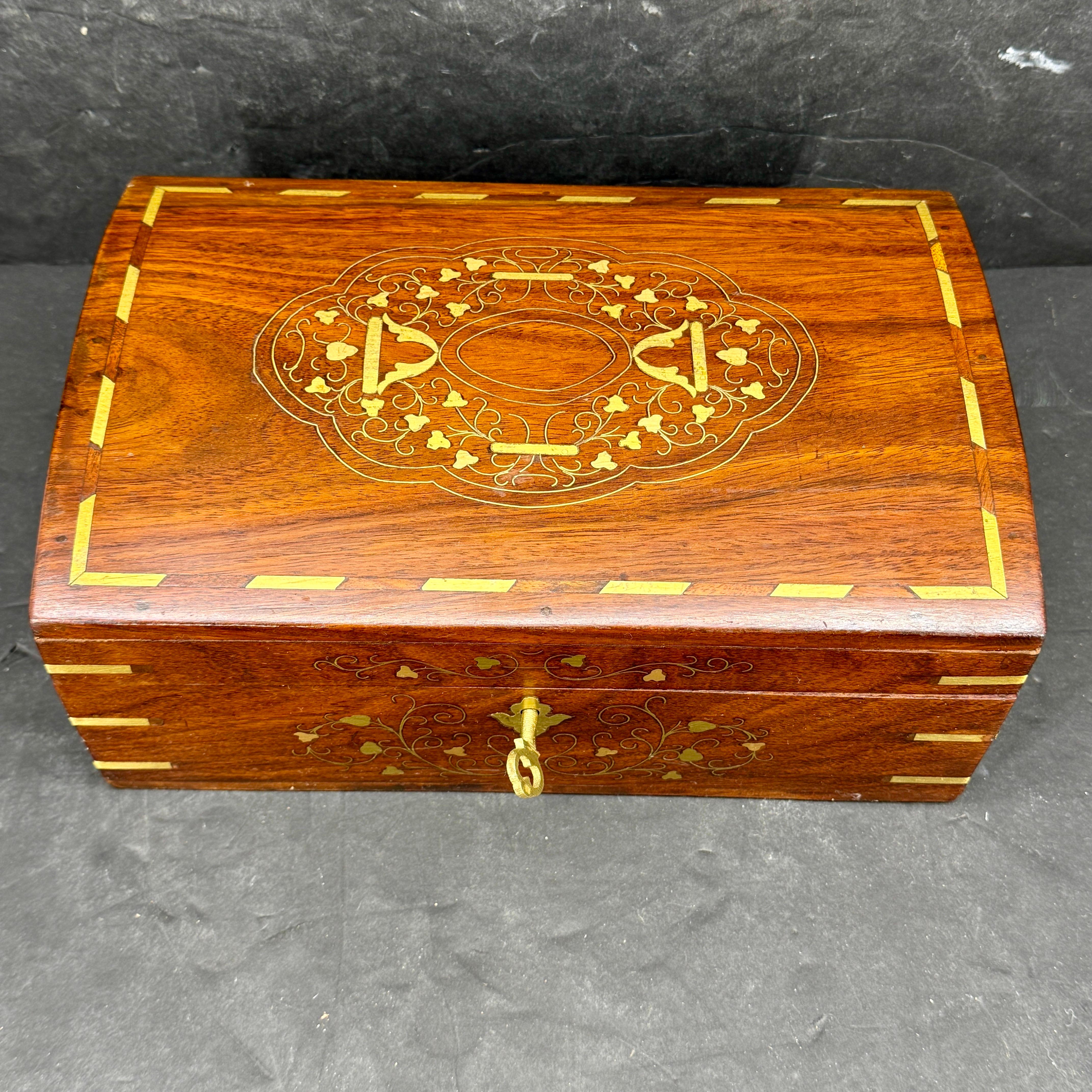 Large Dome Shaped Rosewood Jewelry Box. This elegant box, lined in royal blue velvet with an interior mirror, can be used to store your favorite pieces of jewelry and features removable tray with compartments. The key and lock is in good working