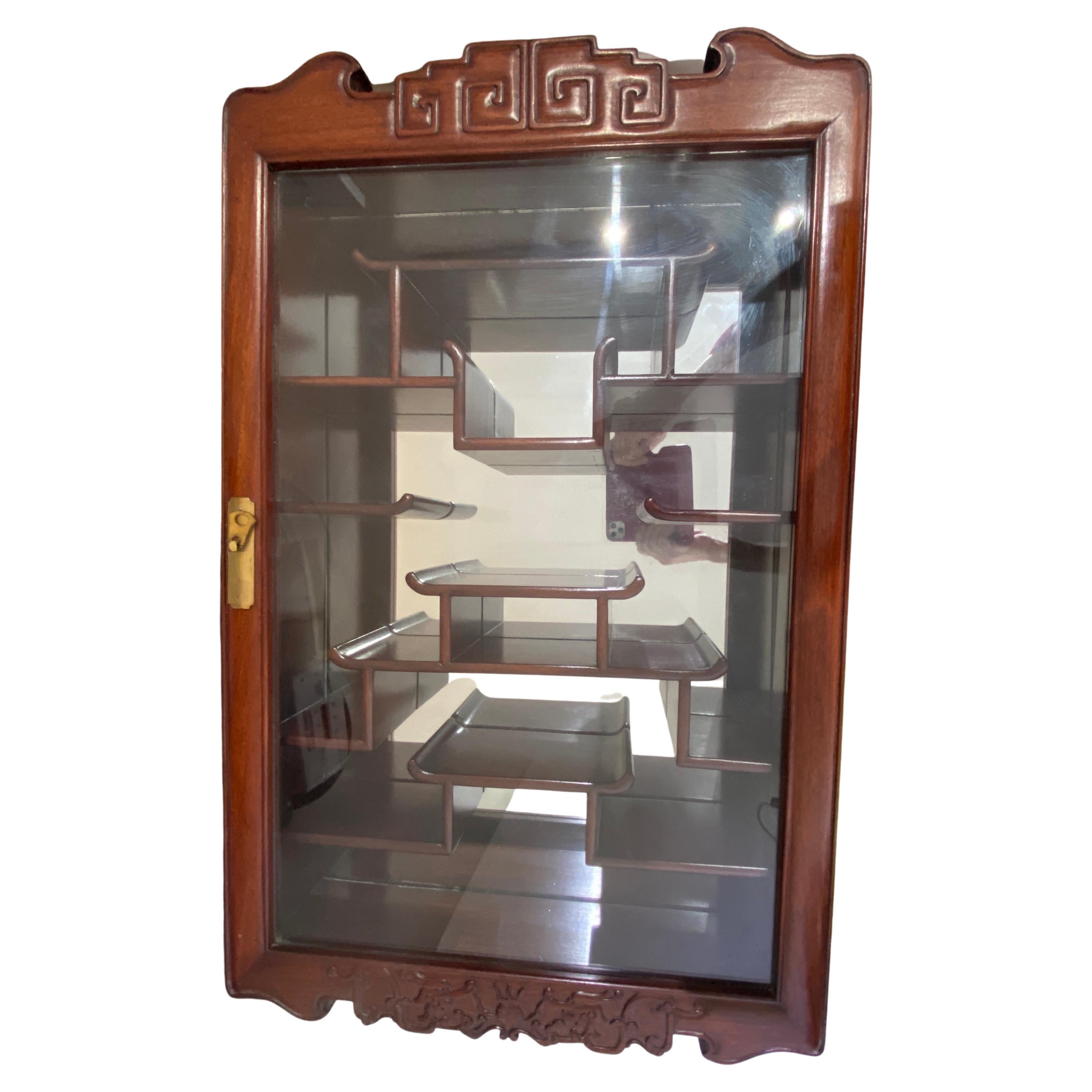 This stylish and classic Chinese rosewood cabinet is the perfect piece to hold your special collectables.