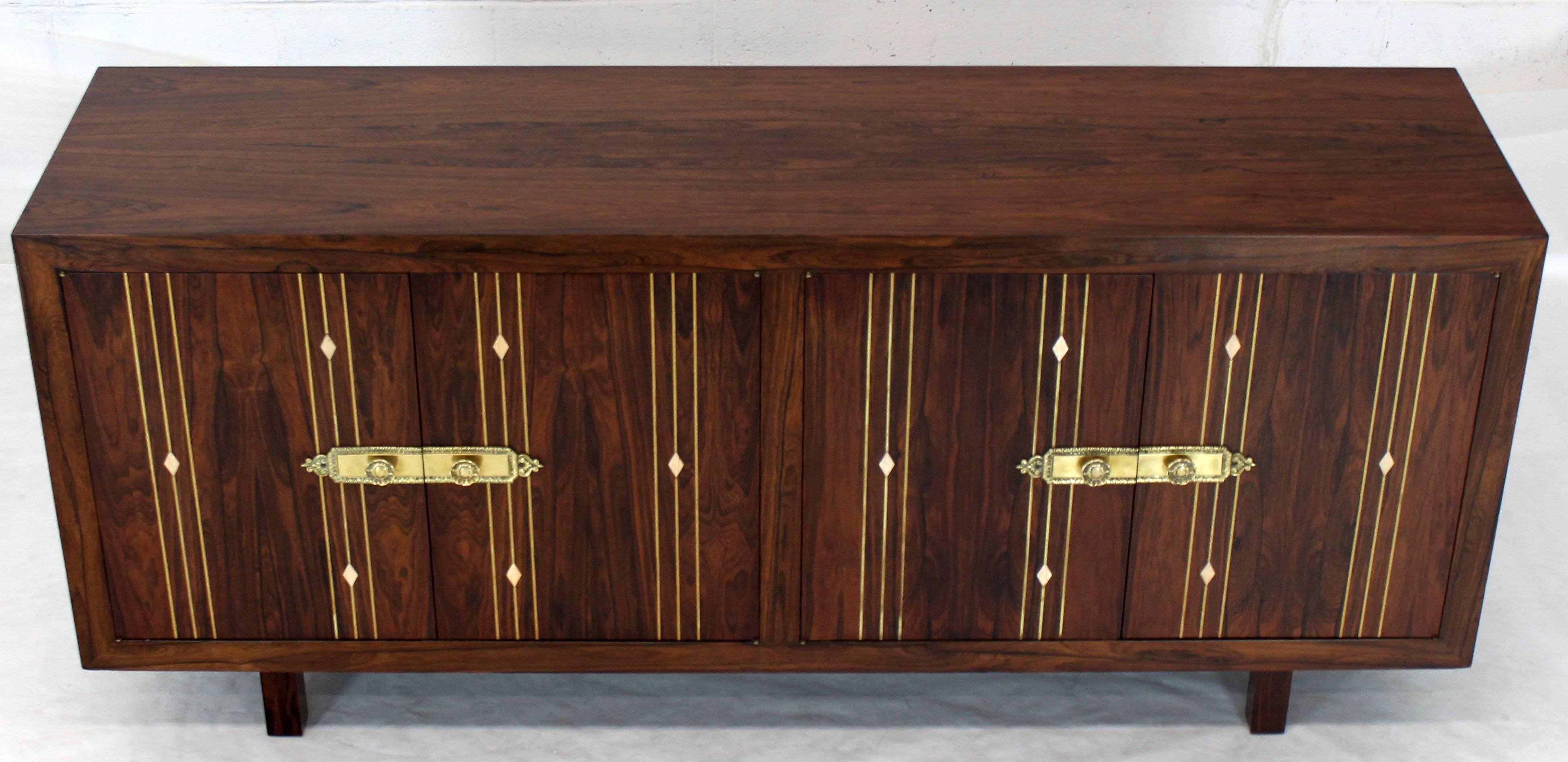 Midcentury Danish modern rosewood long credenza server with two drawers brass hardware and decorative inlay.