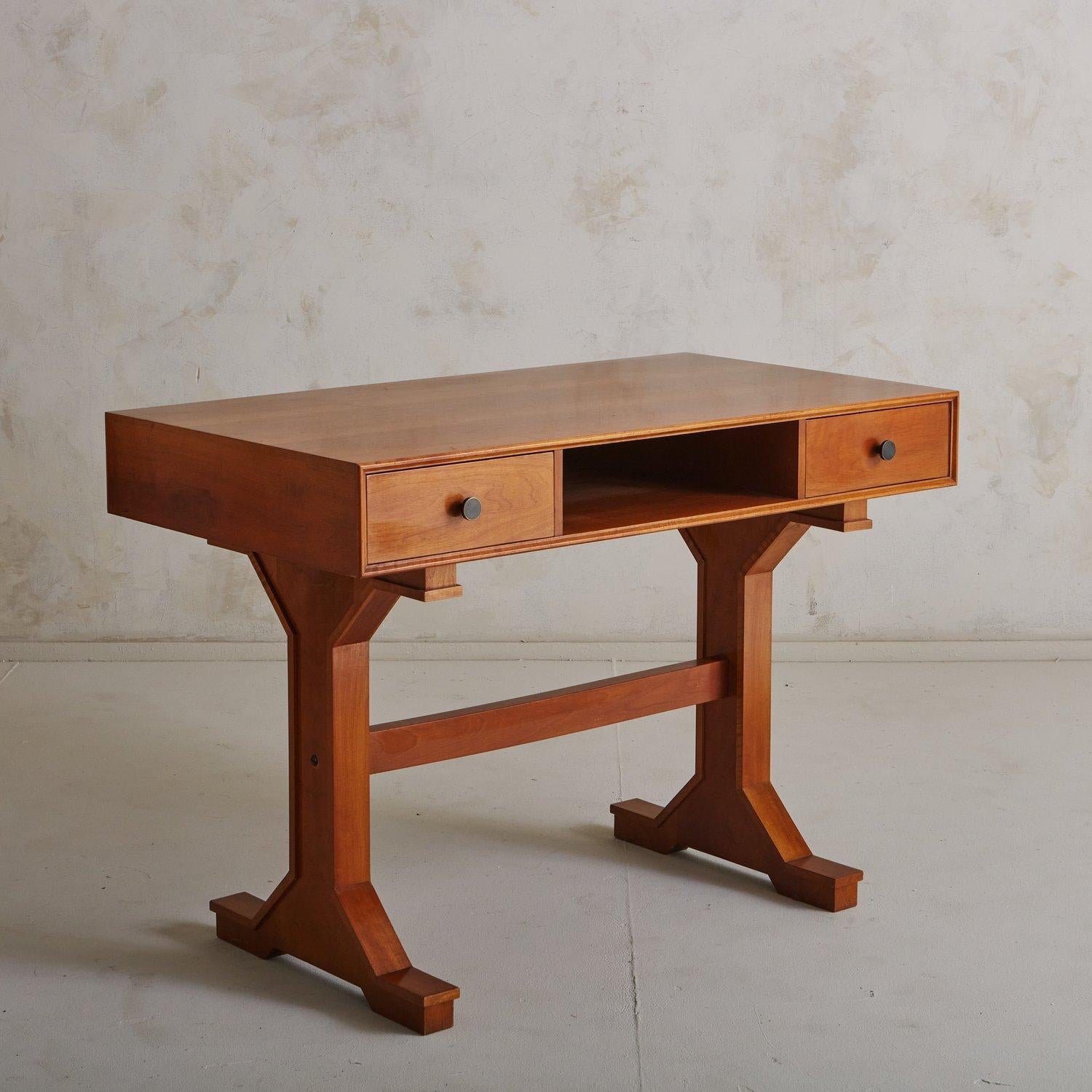 An elegant vintage Italian writing desk by Gianfranco Frattini. This desk was constructed with rosewood and features angular, clean lines. It has two drawers with round metal pulls and an open central space for additional storage. The rectangular