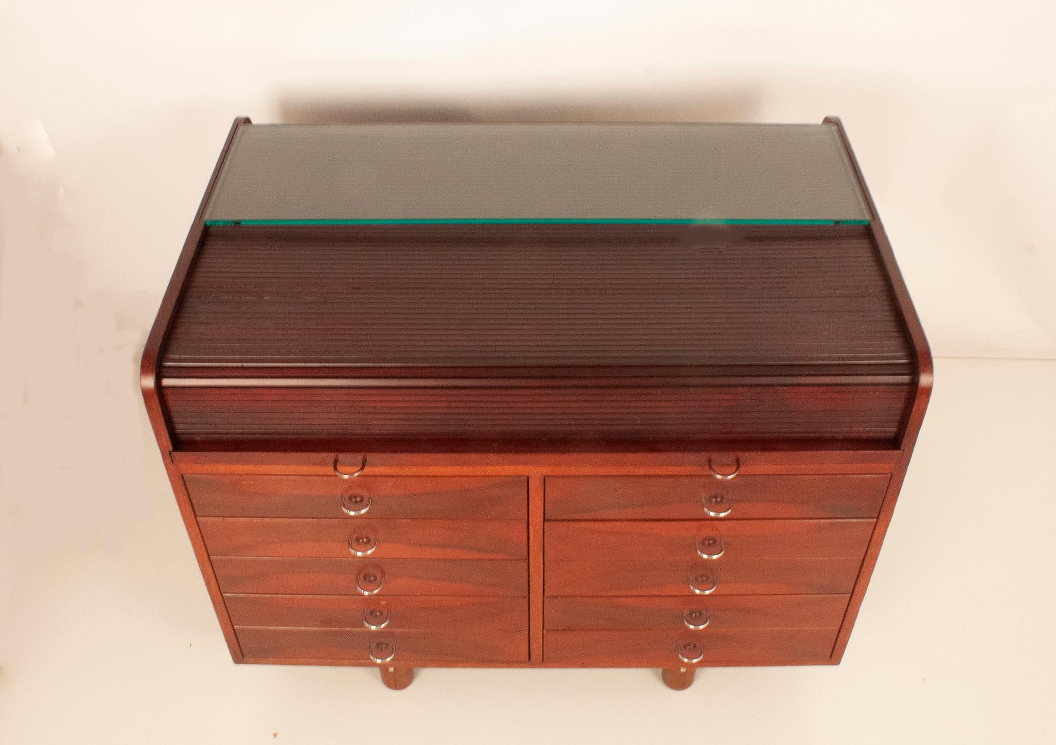 Hardwood writing desk designed in 1960's by Gianfranco Frattini for Bernini, Italy. Tambour top that hides small drawers and a pull out leather writing surface. Ten drawers in front and fours drawers inside, plus various little drawers in white